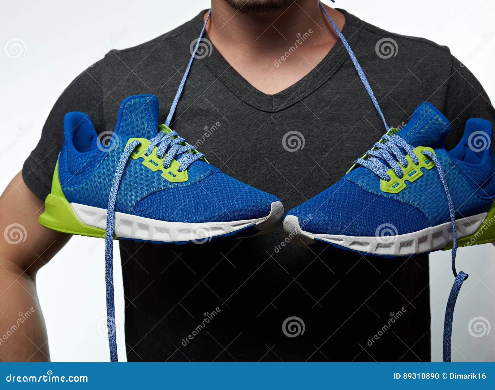 https://thumbs.dreamstime.com/z/man-hanging-shoes-neck-laces-sport-colorful-blue-running-sneakers-89310890.jpg