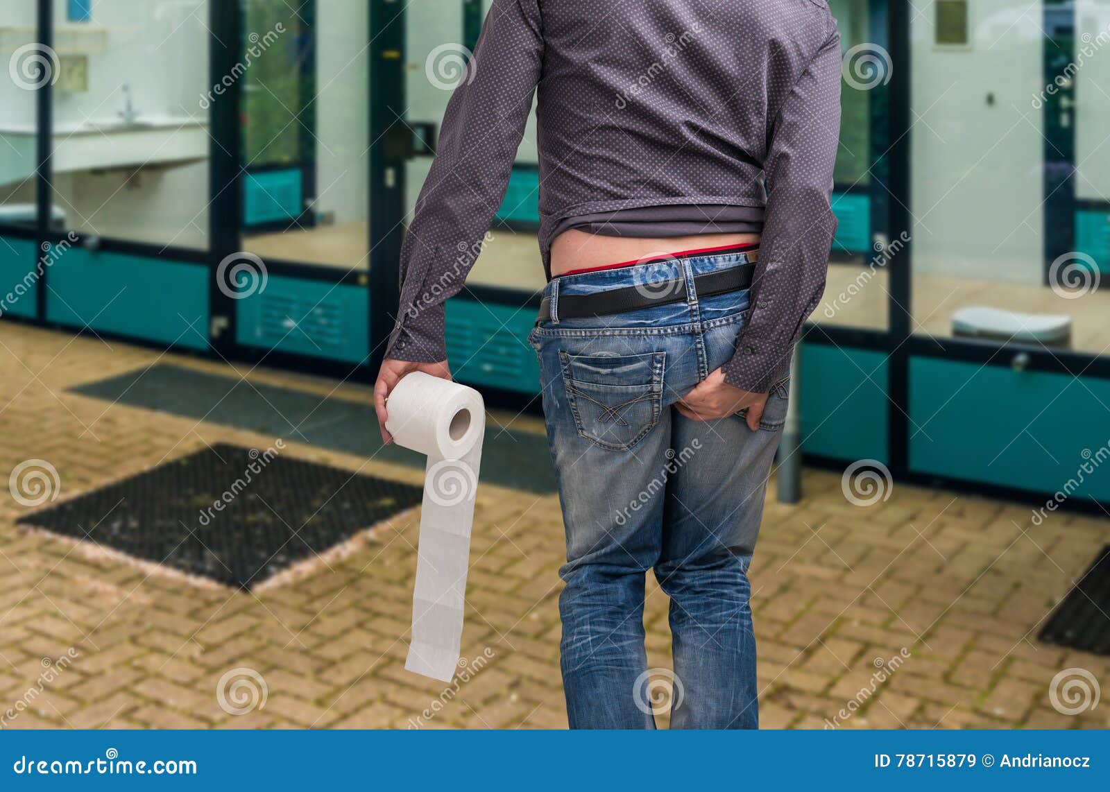 man has diarrhea. man holding toilet paper and his butt.