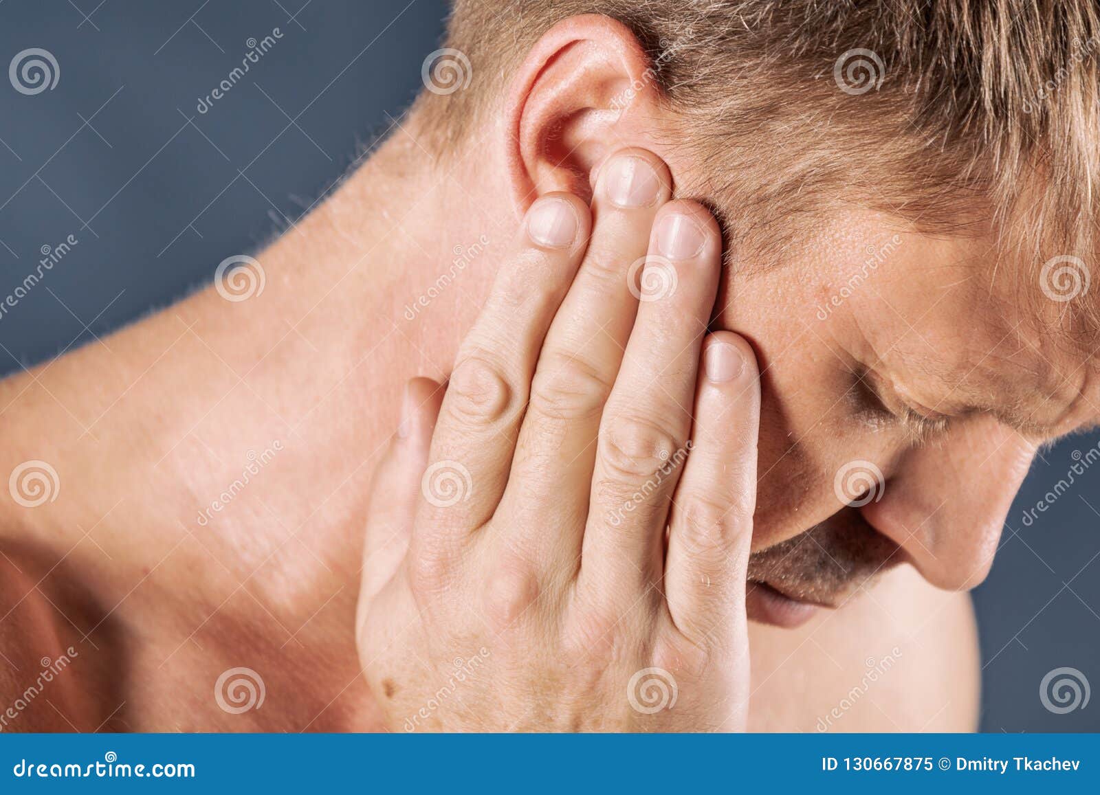 Man Has a Sore Ear. Man Suffering from Headache on Blue Background