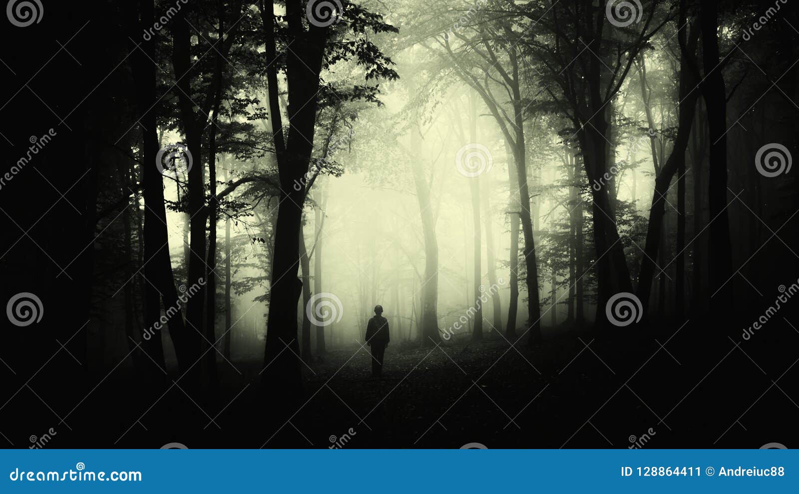 man in creepy forest with fog on halloween