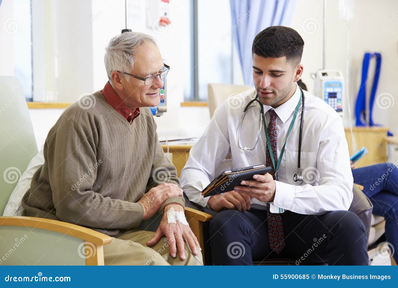 Man Having Chemotherapy with Doctor Using Digital Tablet Stock Image