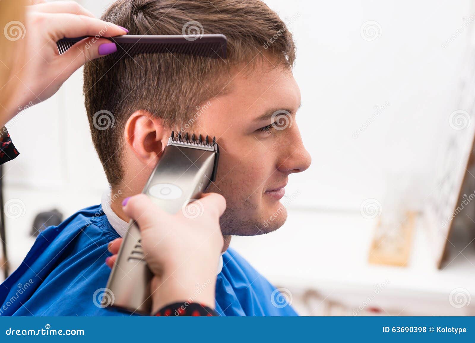 man having hair cut by stylist in salon