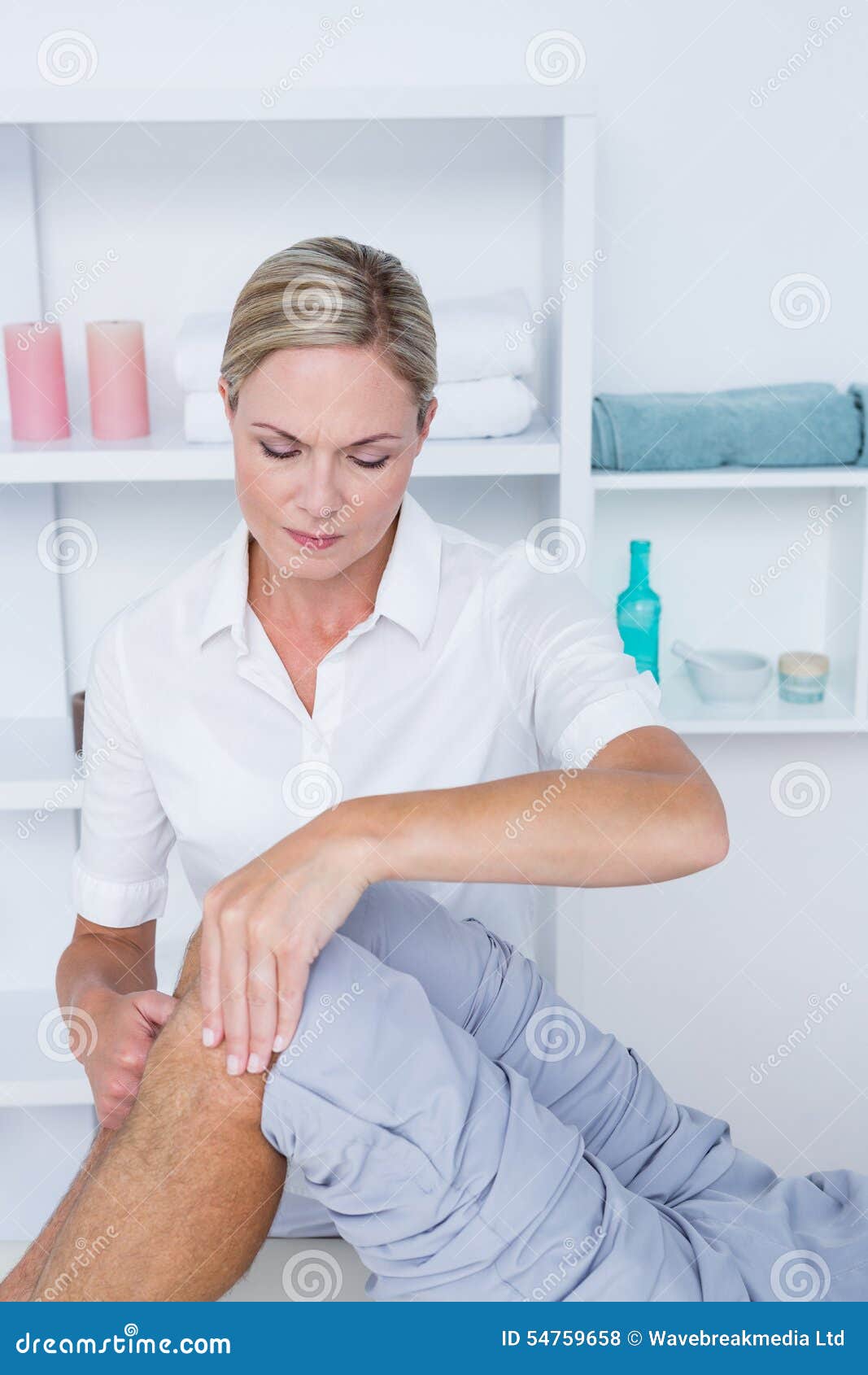 Man having knee massage stock photo. Image of specialist 54759658