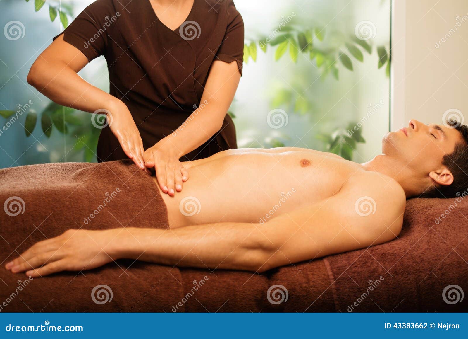man having massage in spa