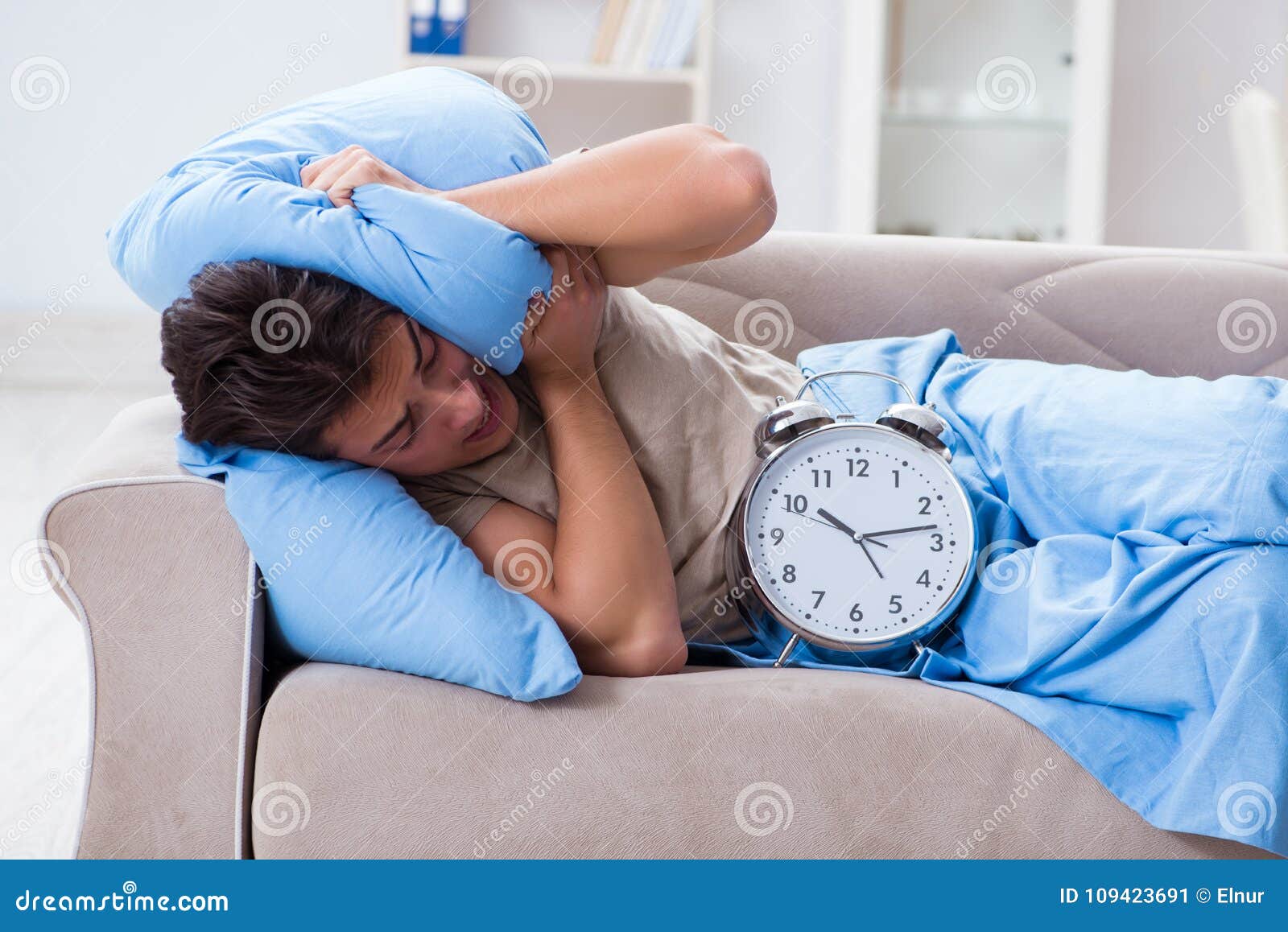 The man having trouble waking up with alarm clock stock image image