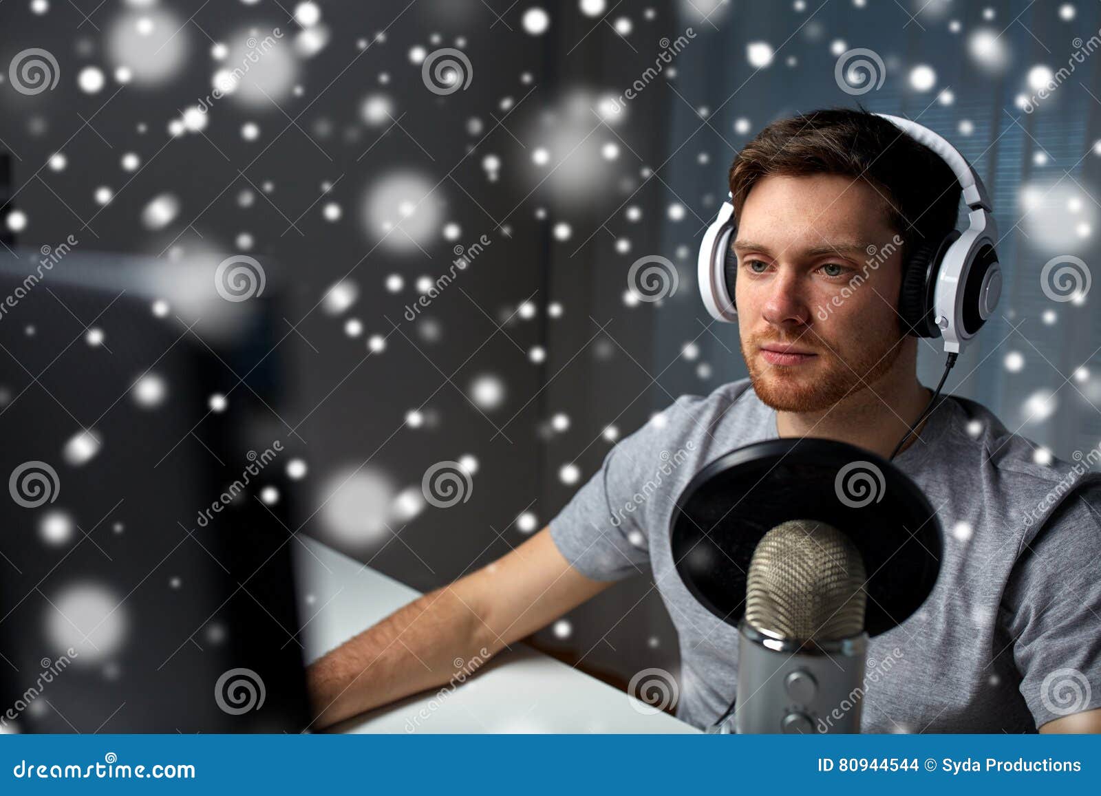man in headset playing computer video game at home