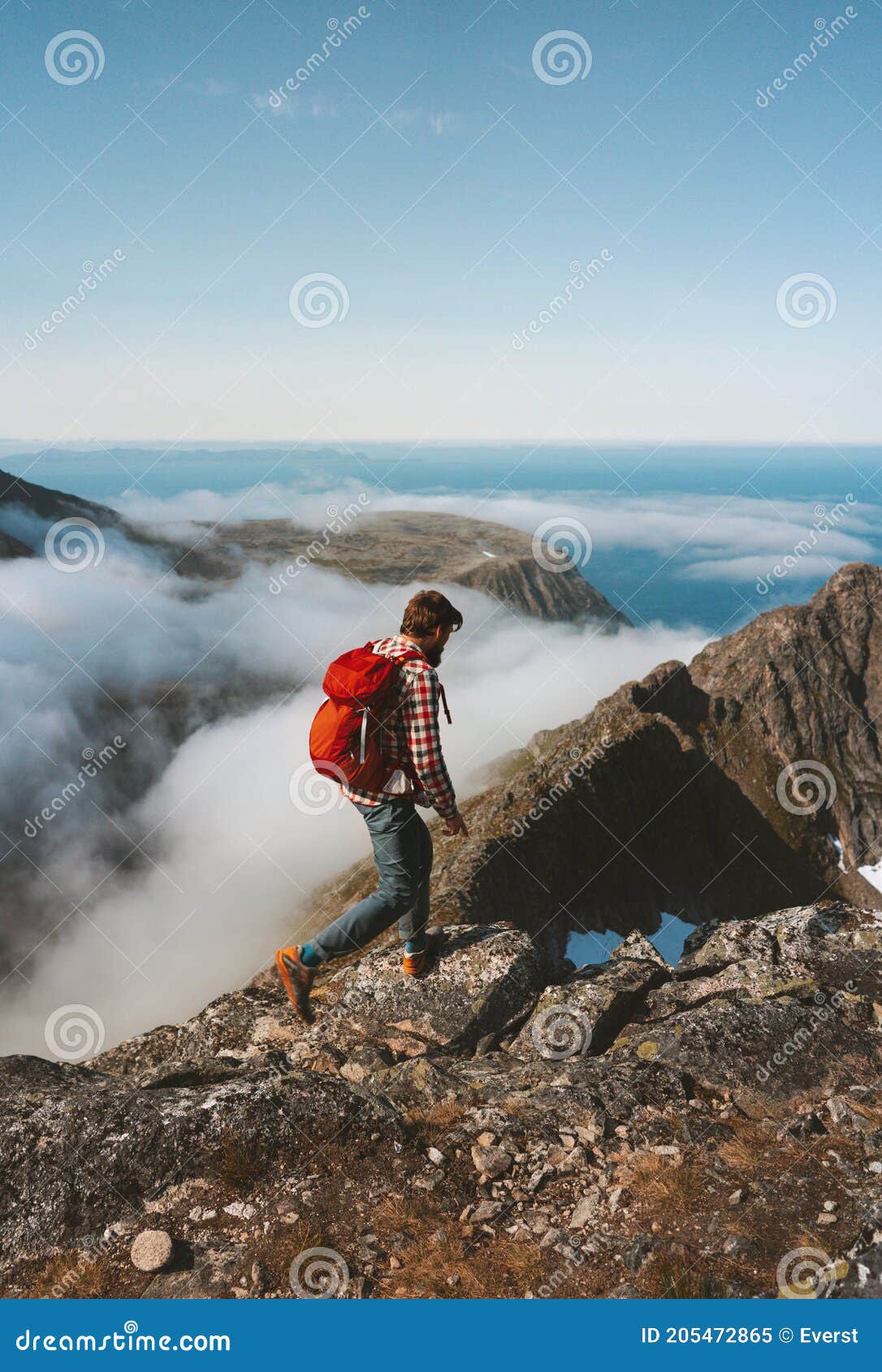 man hiking solo on mountain ridge travel lifestyle adventures active outdoor vacation