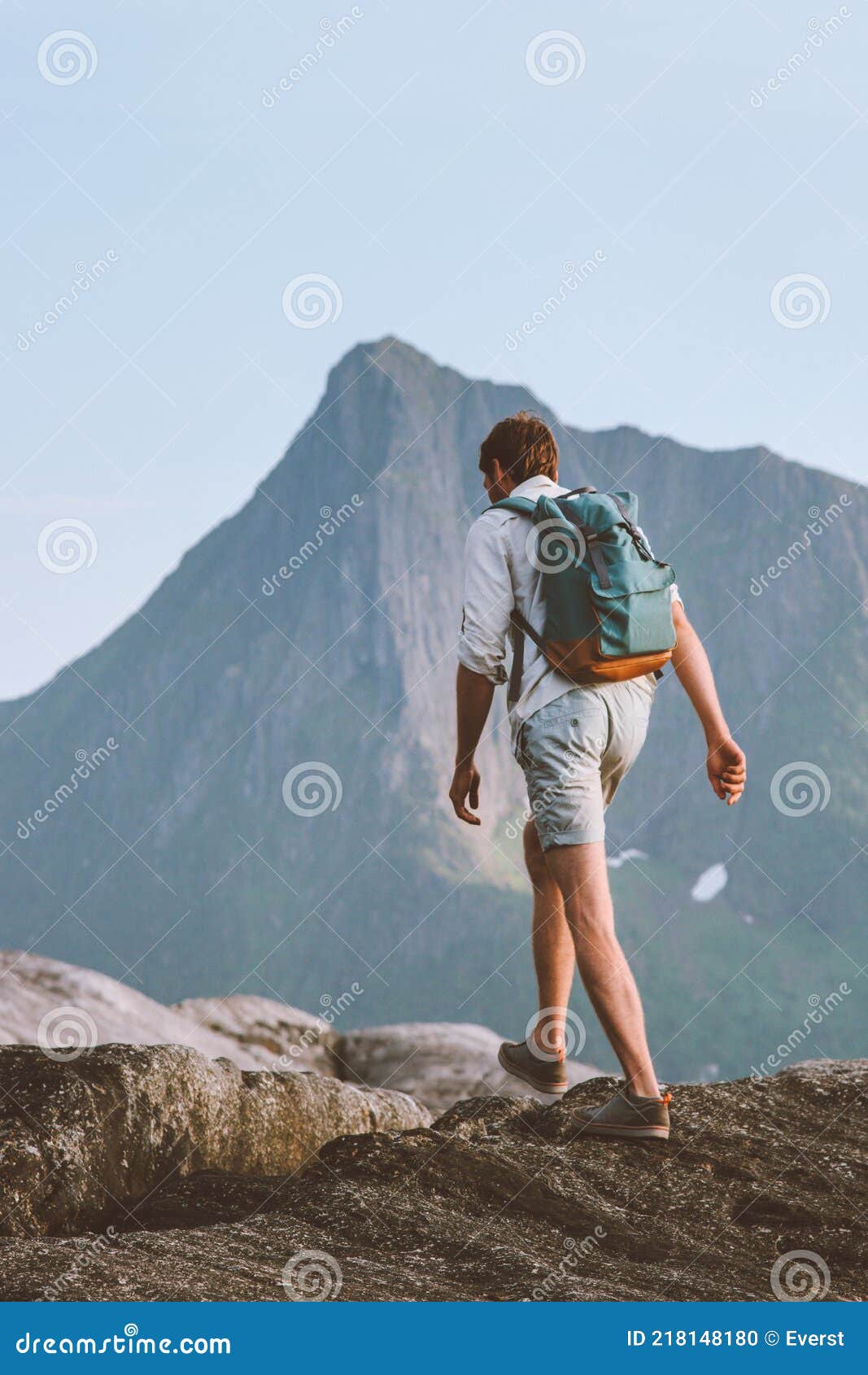 man hiking traveling alone in norway vacations backpacking eco tourism in mountains