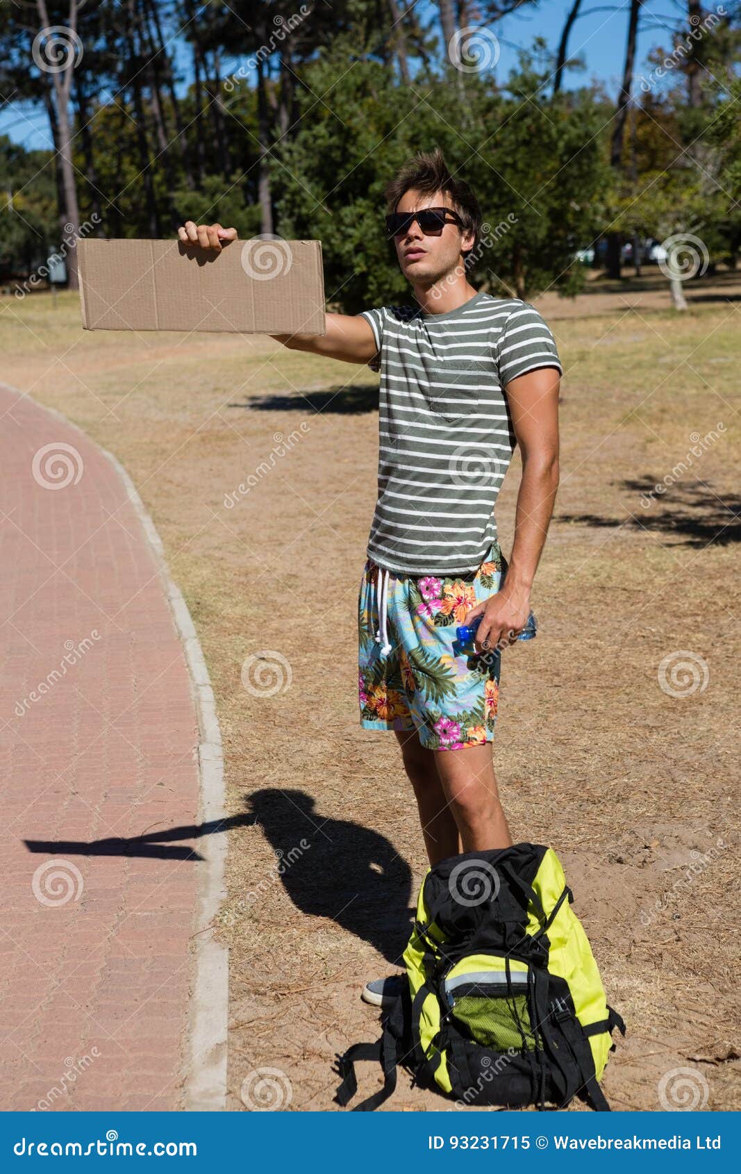 Man Hitchhiking at Roadside Stock Image Image of parkland, hispanic