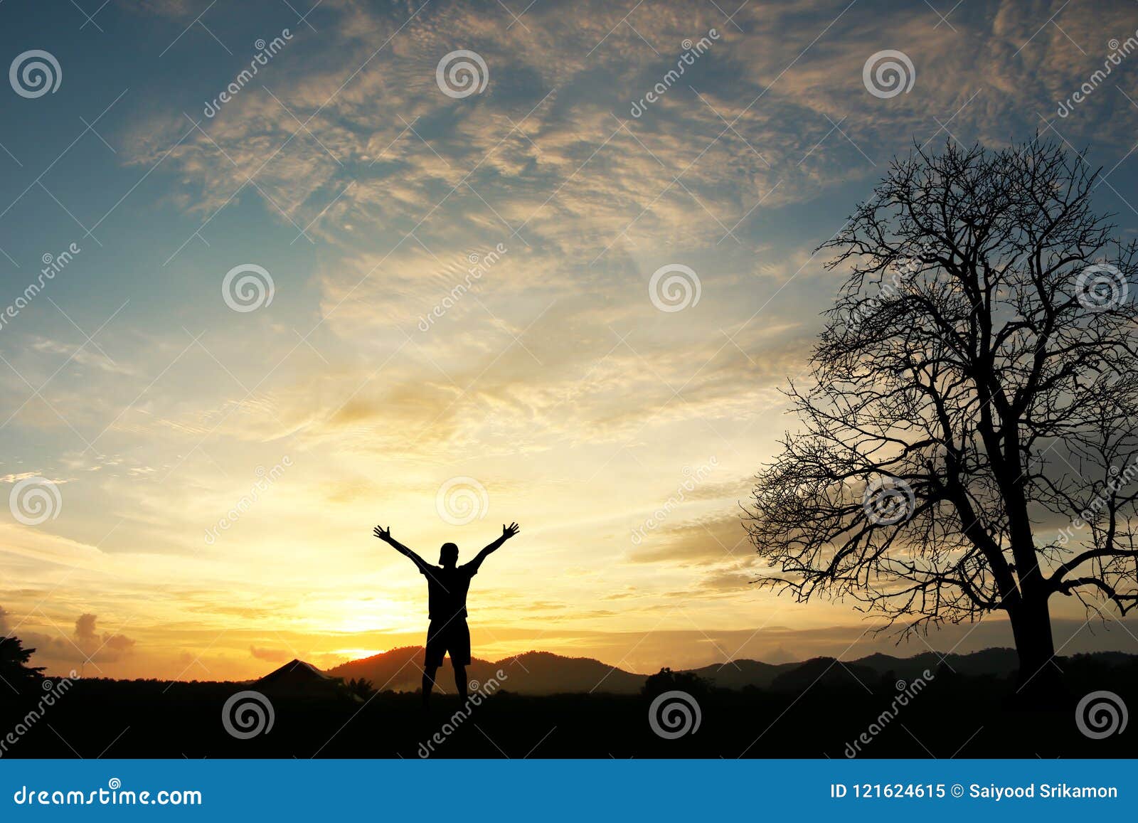 man holding arms up in praise