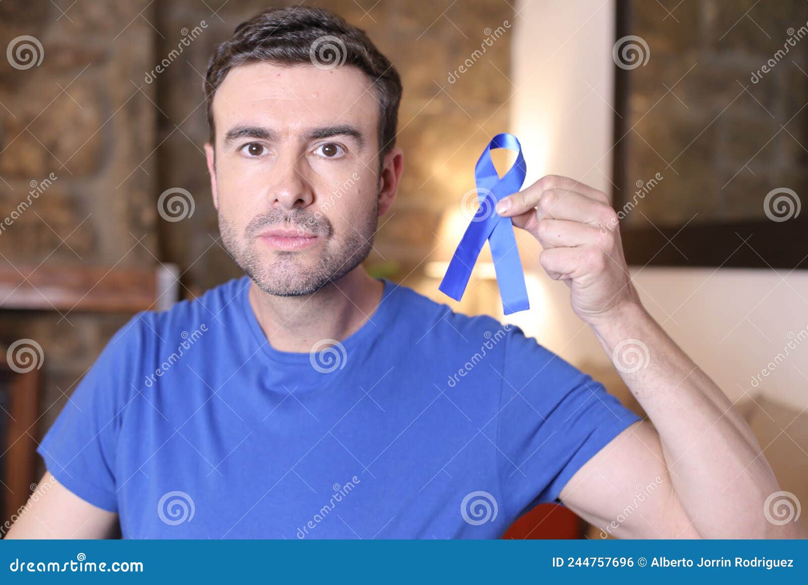 Man holding a blue ribbon stock photo. Image of health 244757696