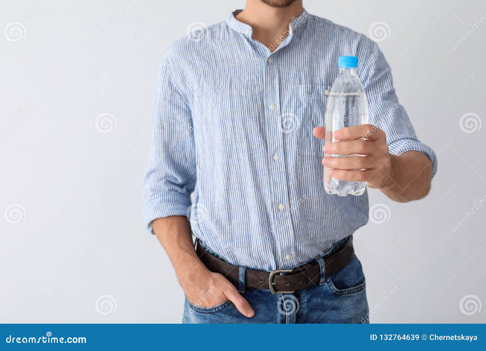 Man Holding Bottle of Pure Water on White Background Stock Image