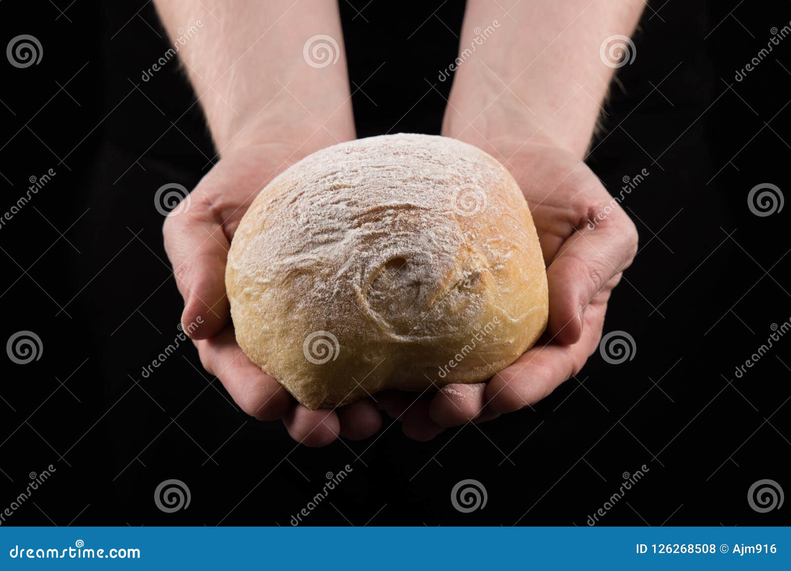Man Holding Bread with Both Hands, Helping Hands Giving Bread.Centered