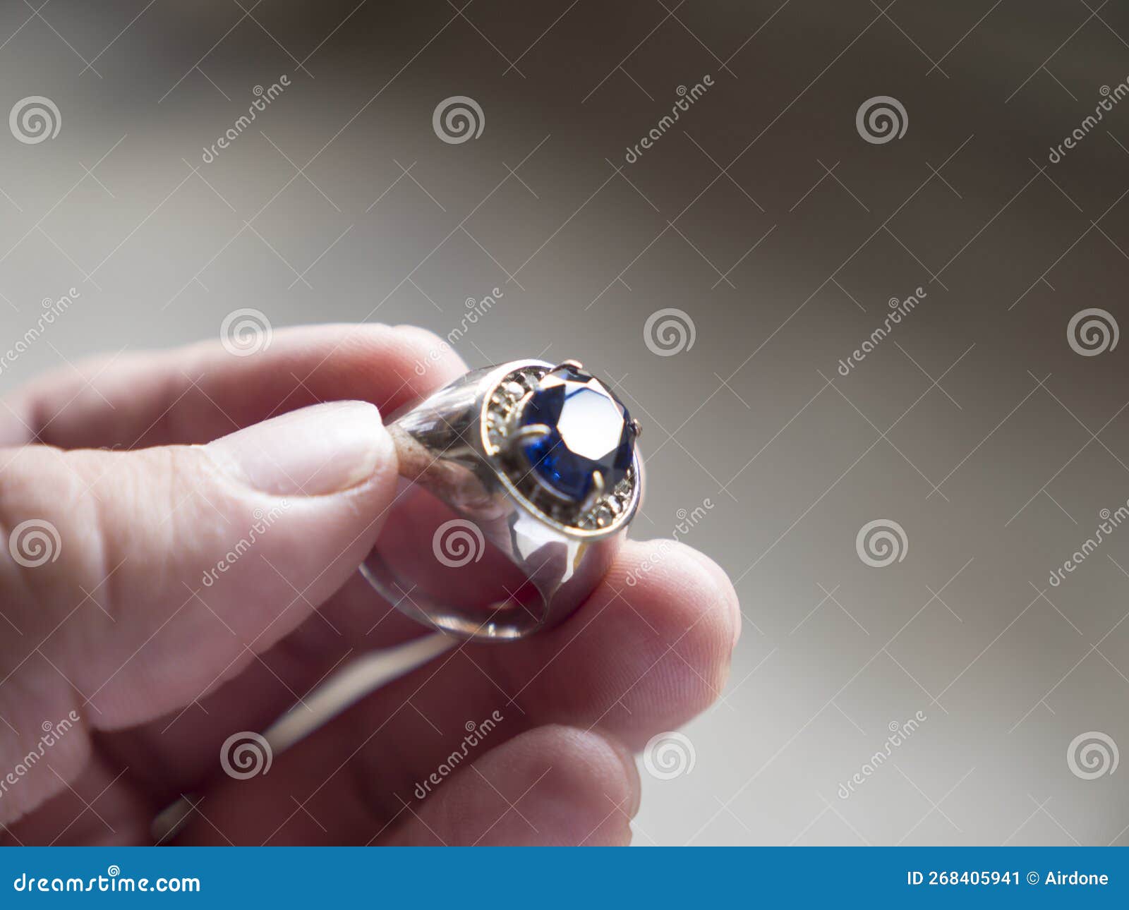 Man Holding Clue Stone Silver Ring To Check Its Quality Stock Image