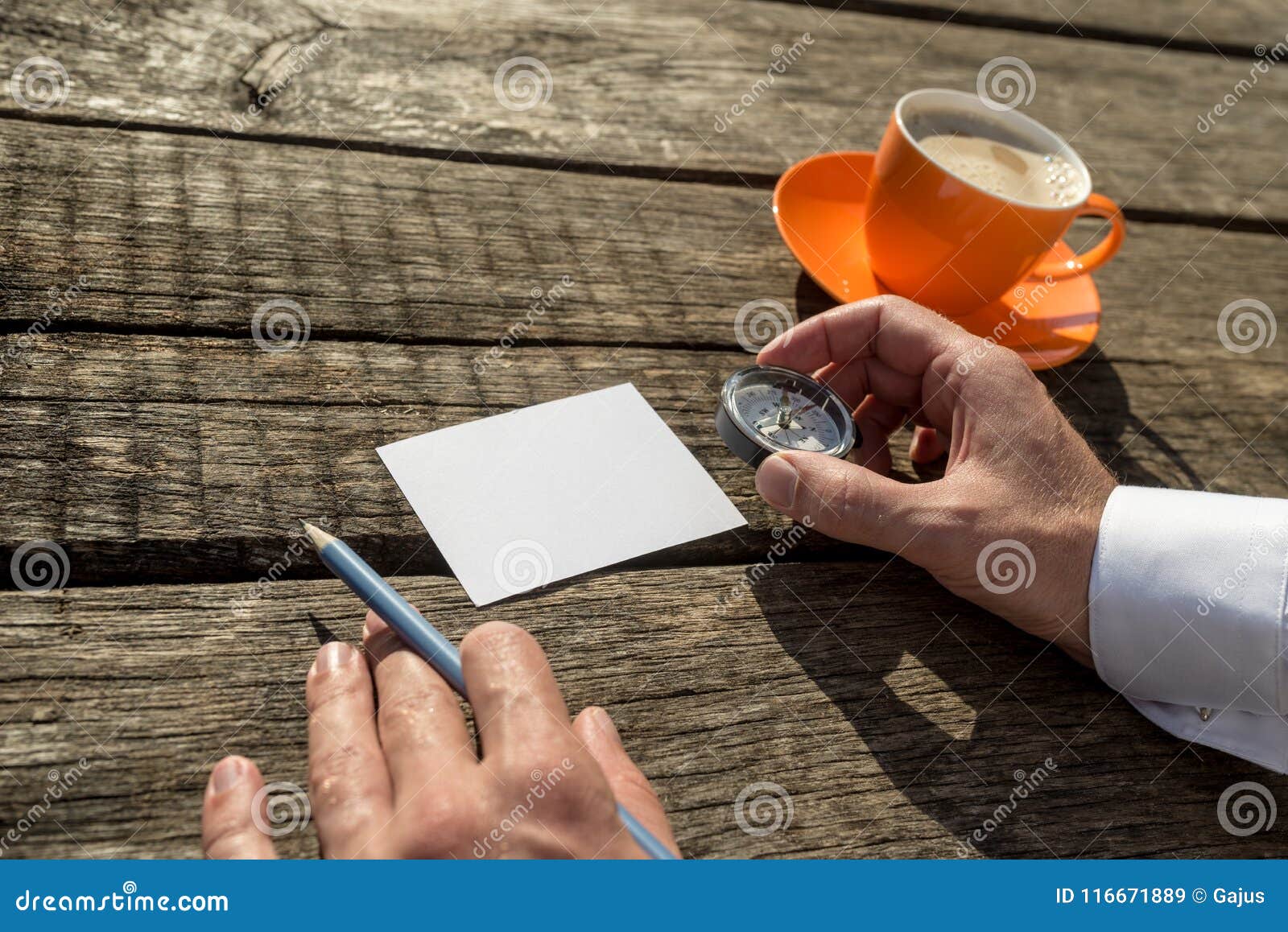 man holding compass and pencil ready to write on blank paper