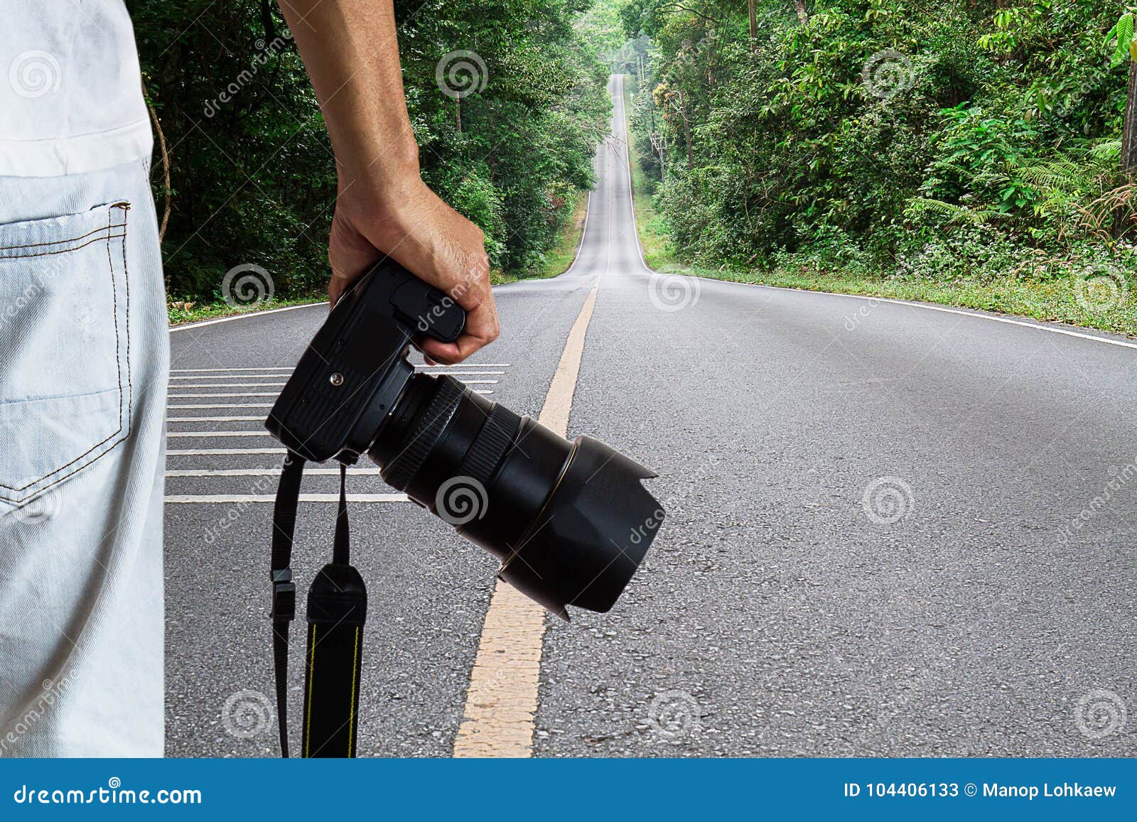 Man Holding Dslr Digital Camera on Blurred Straight Road in National Park  Background Stock Image - Image of natural, asia: 104406133
