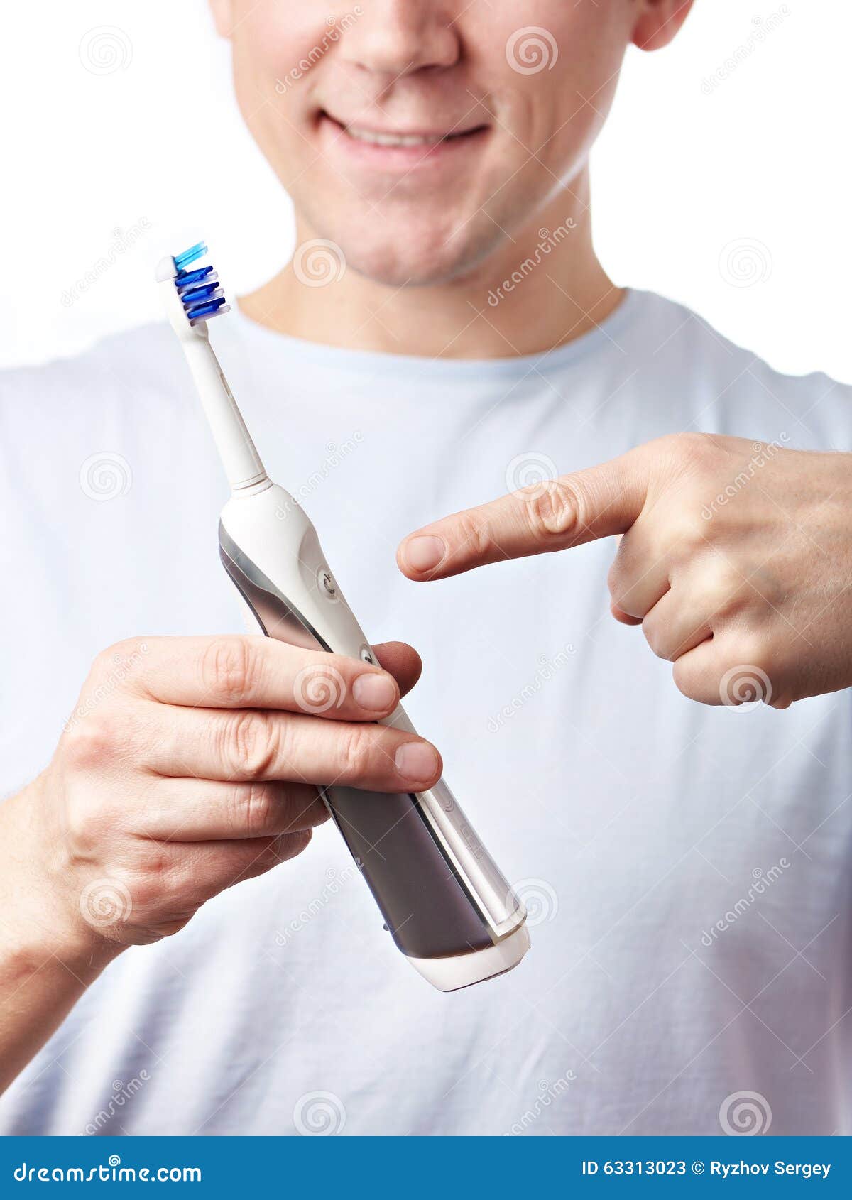 Man Holding an Electric Toothbrush and Points To it Stock Image Image