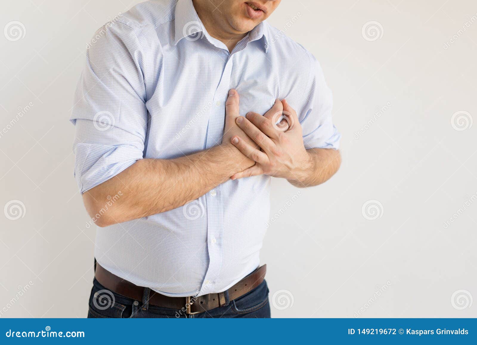 man holding his chest in pain. heart attack symptom