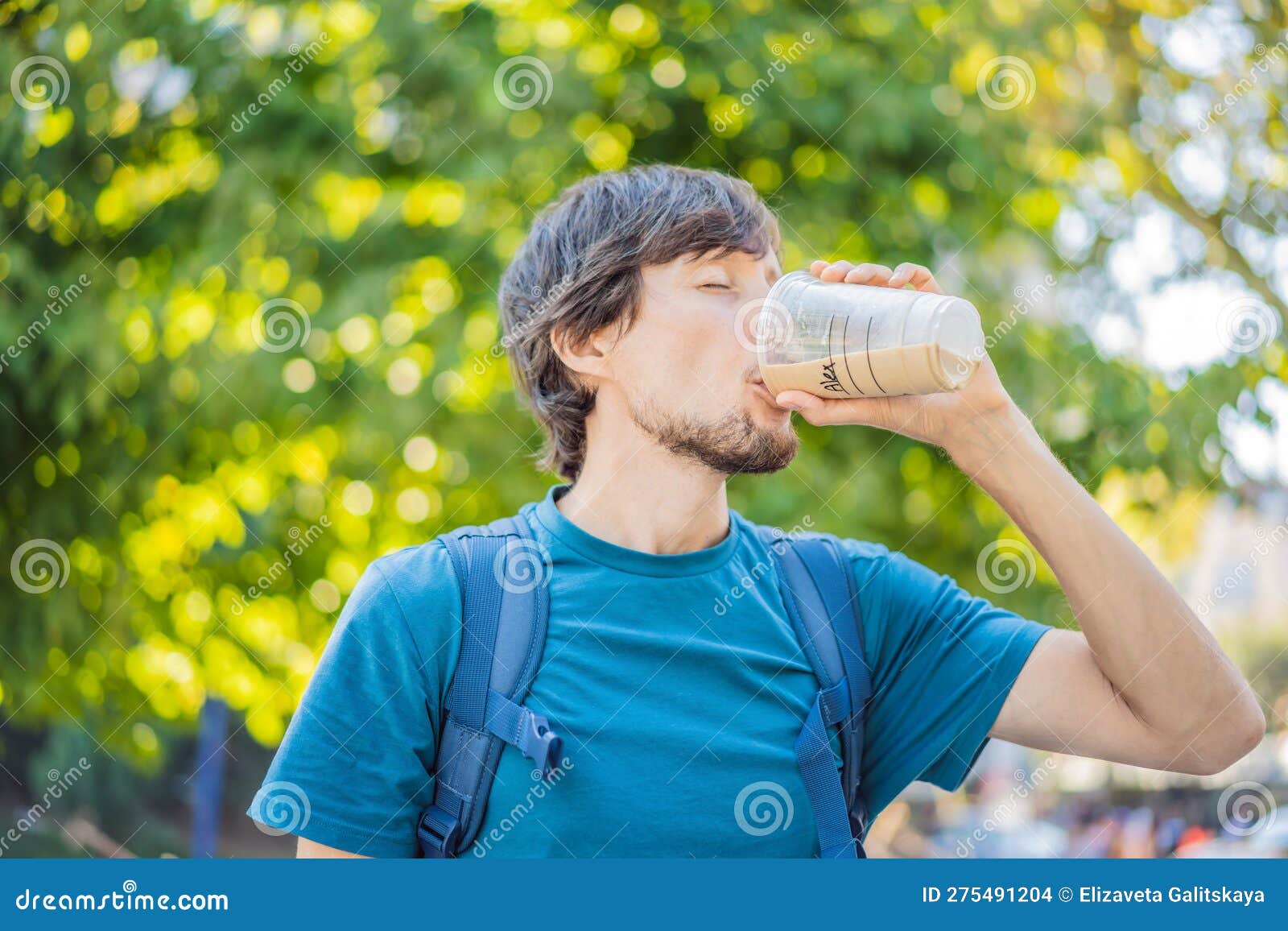Man Holding an Iced Coffee in a Plastic Togo Cup Stock Photo Image