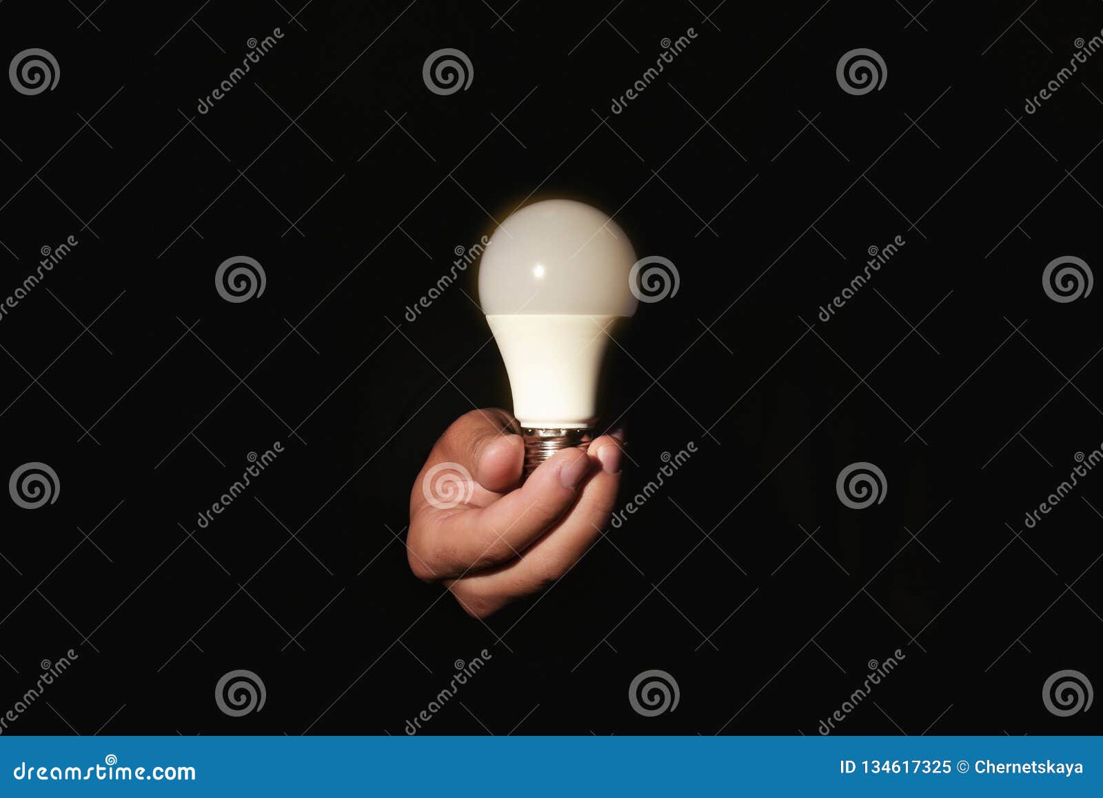 Man Holding Modern Lamp Bulb On Dark Background Stock Image Image of
