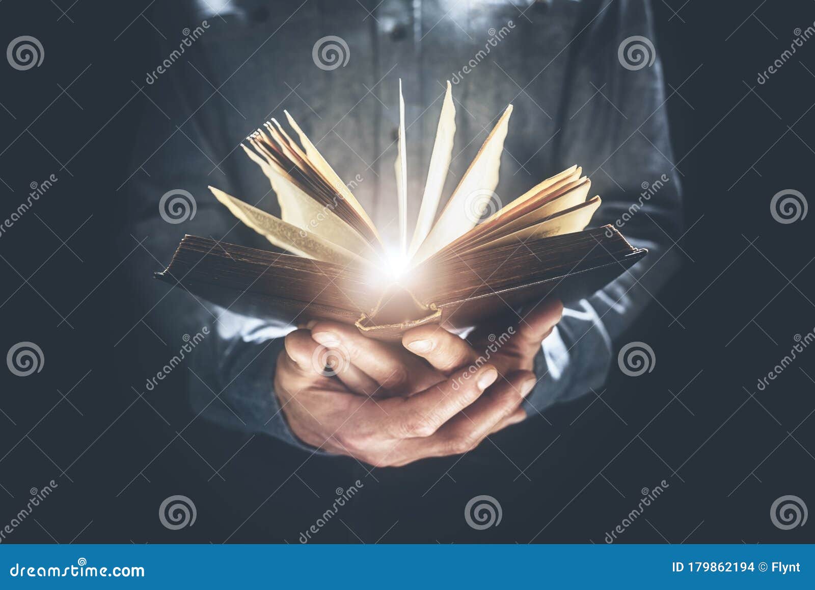 man holding and reading the holy bible or a book