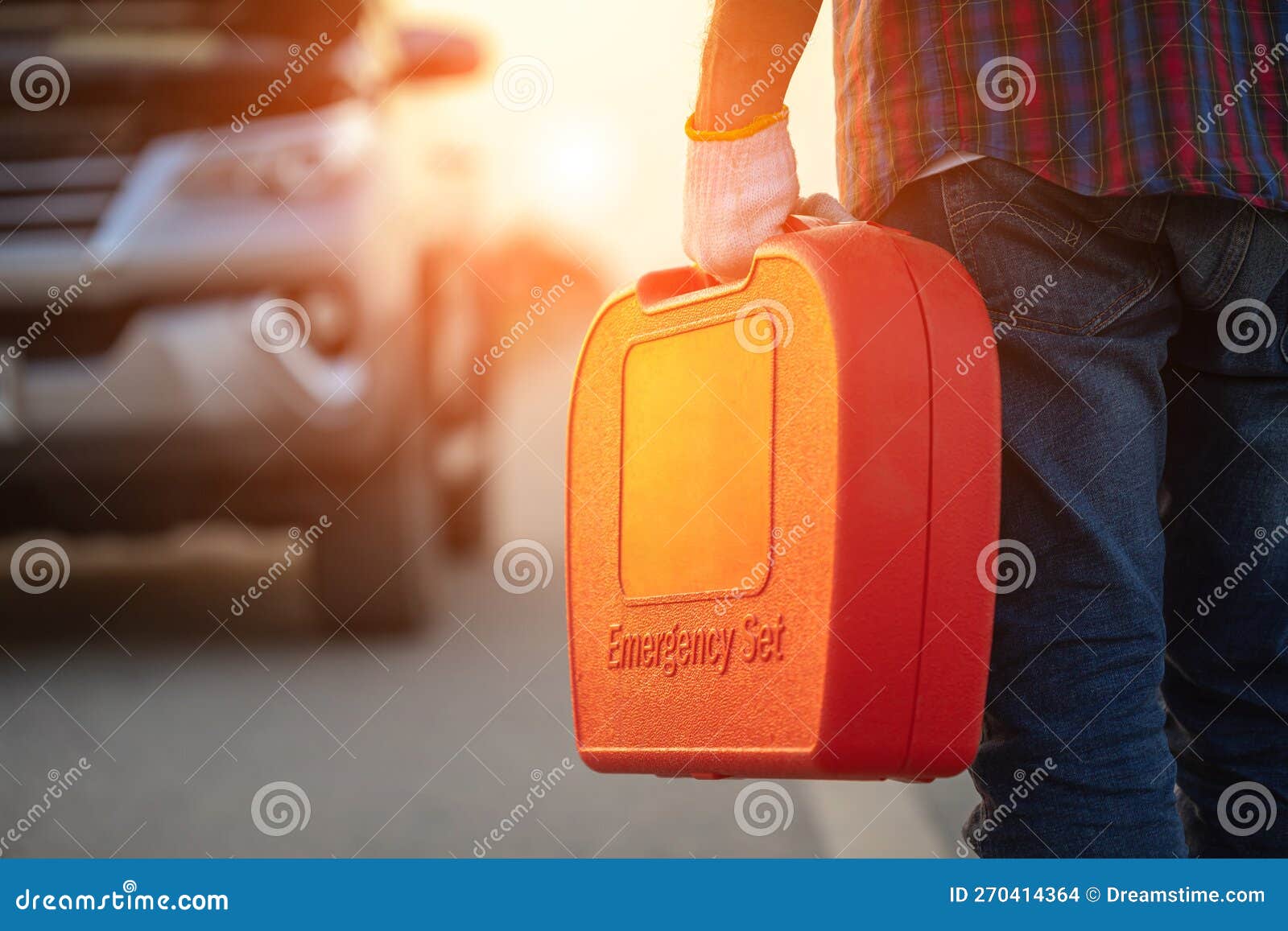 man holding red emergency tools box and standing infront of car on the roadside. car accident, repair and maintenance concept