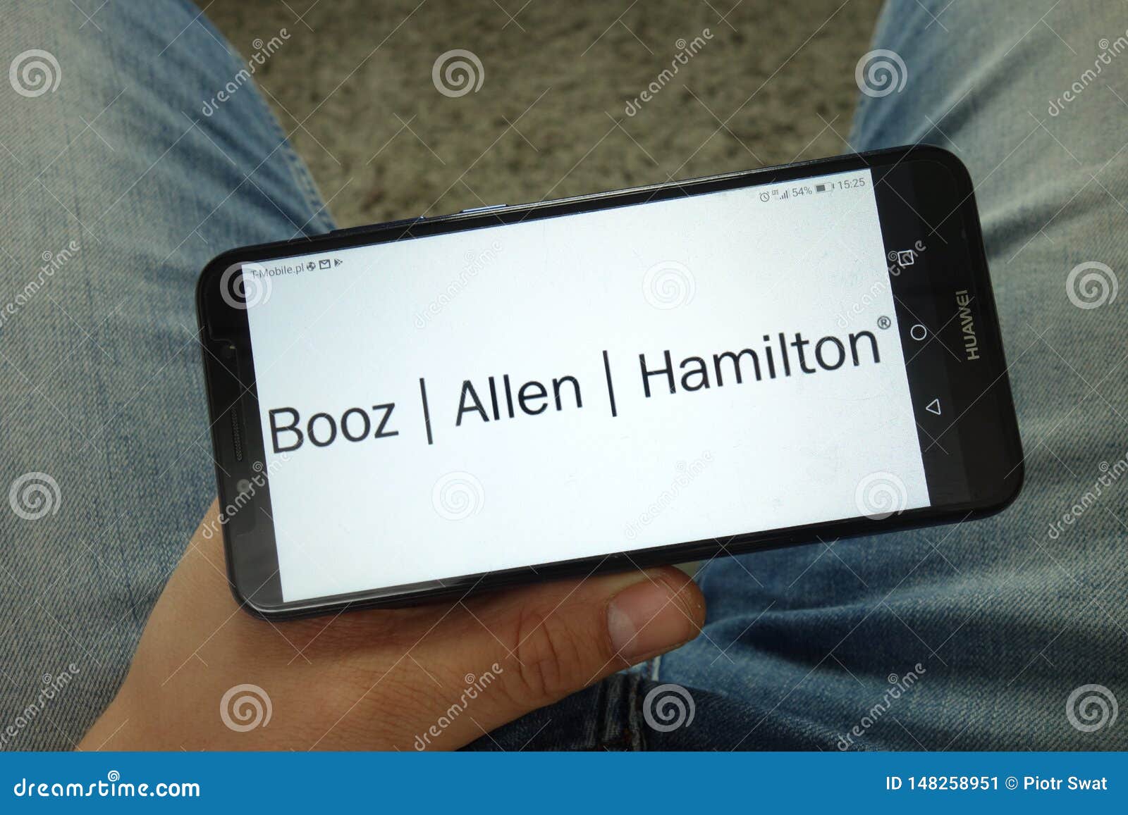 Man Holding Smartphone With Booz Allen Hamilton Holding