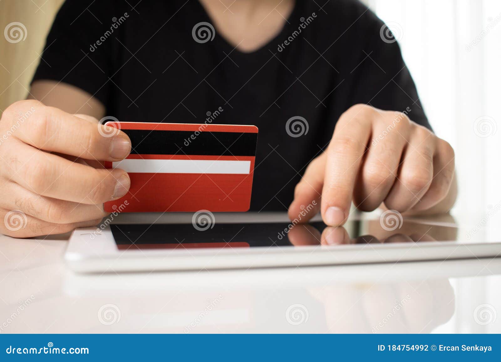 man holding tablet pc and credit card indoor, shopping online