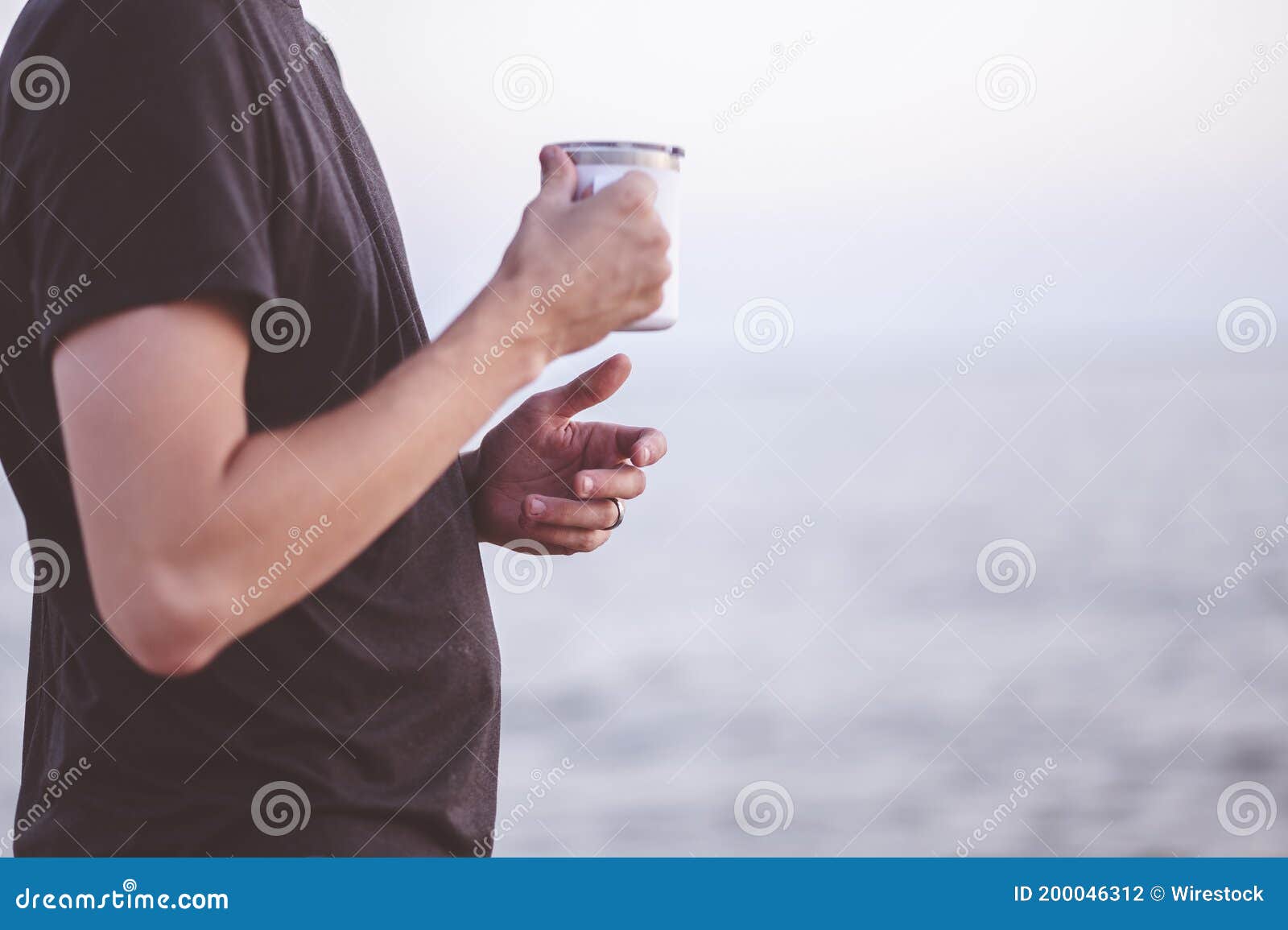Man holding a teacup stock photo. Image of male, shirt 200046312