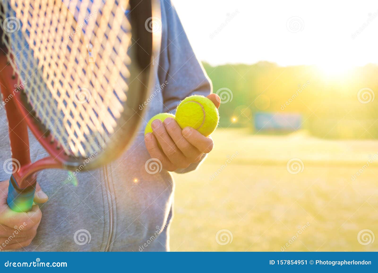 man holding tenis racket and ball at court on sunny day