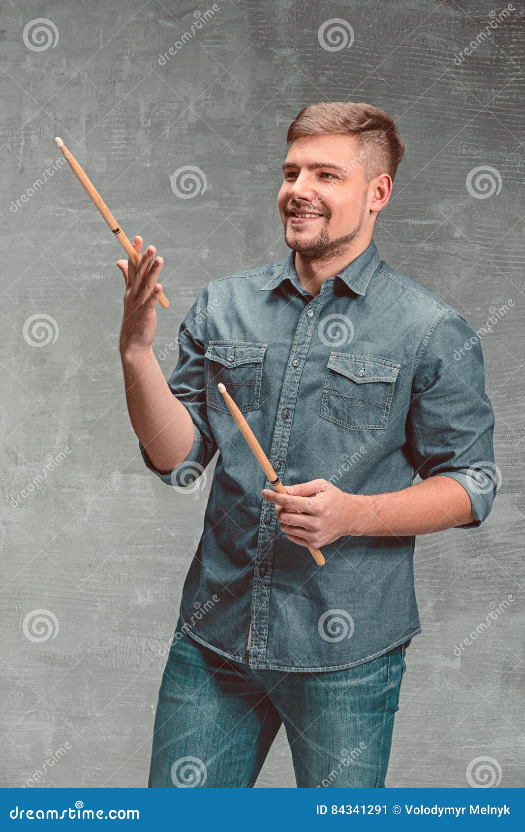 Man Holding Two Drumsticks Over Gray Background Stock Image Image of