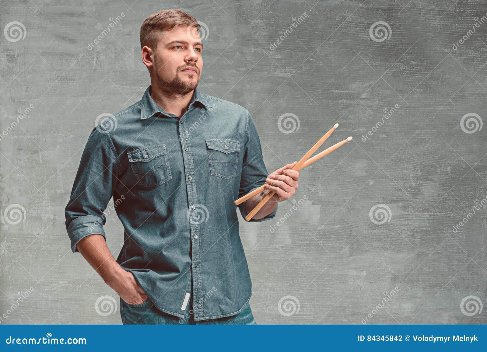 Man Holding Two Drumsticks Over Gray Background Stock Photo Image of