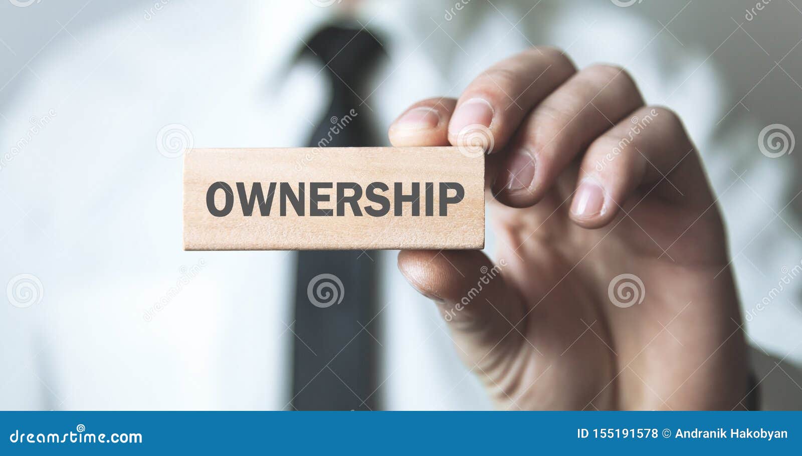 Man Holding Wooden Block With A Ownership Text Stock Photo Image of