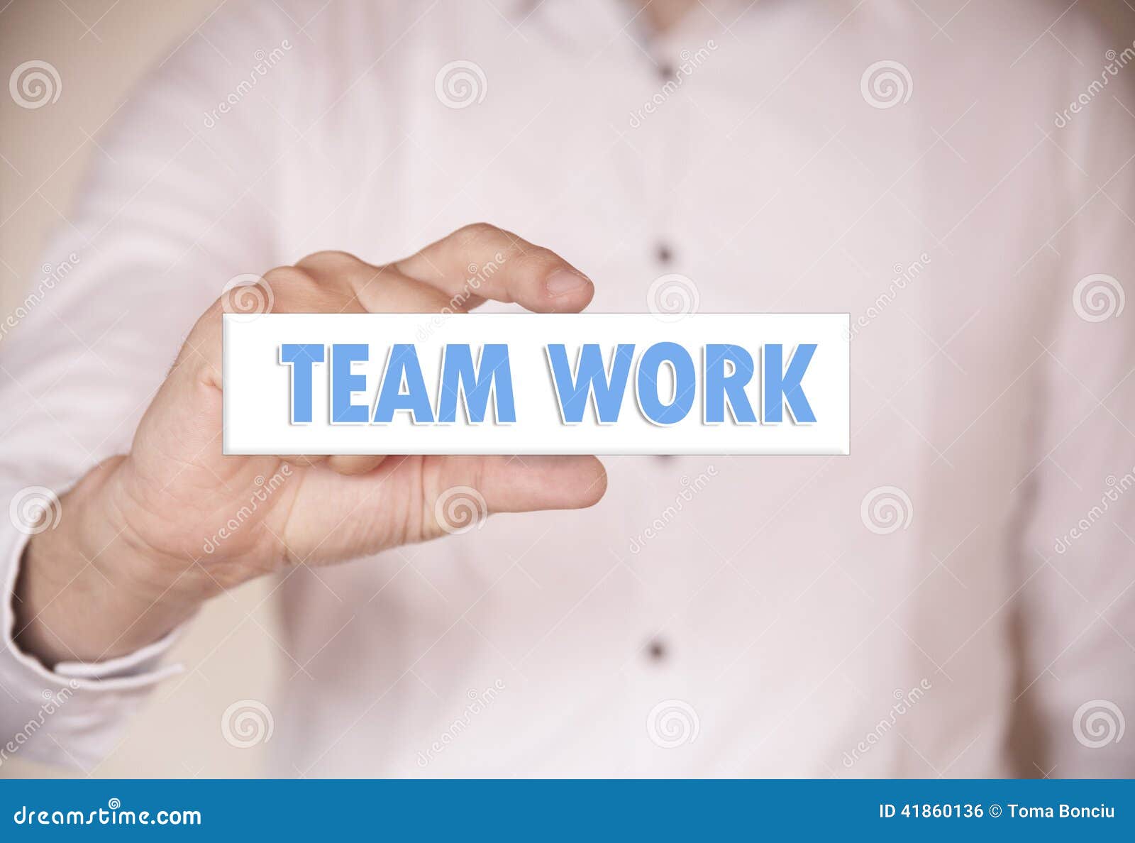 Man Holding a Words Team Work Stock Photo Image of office, push