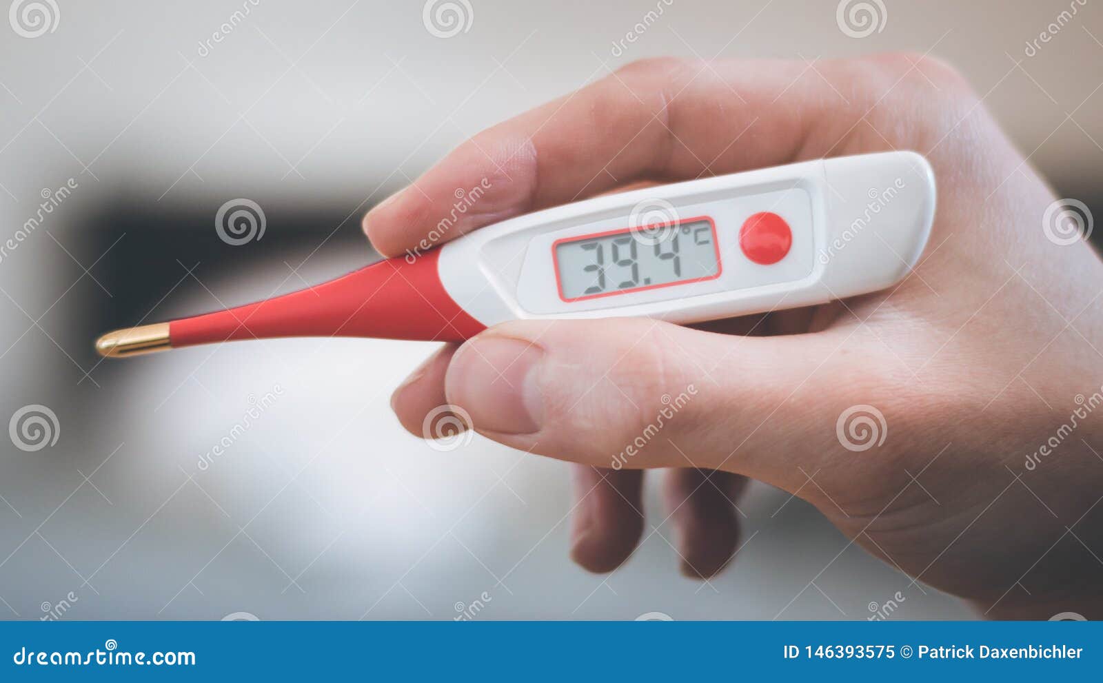 man is holding a fever thermometer in his hand