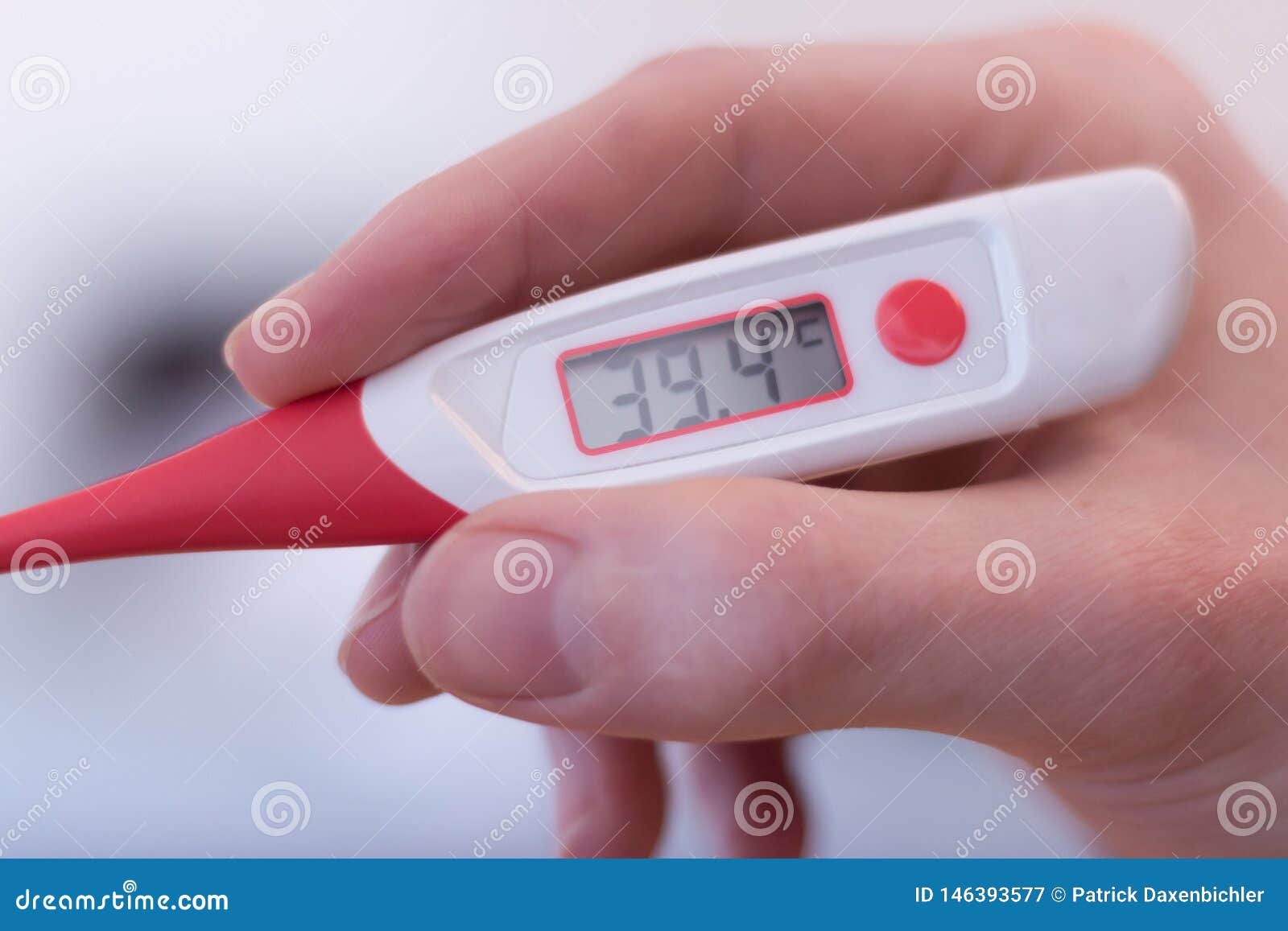 man is holding a fever thermometer in his hand
