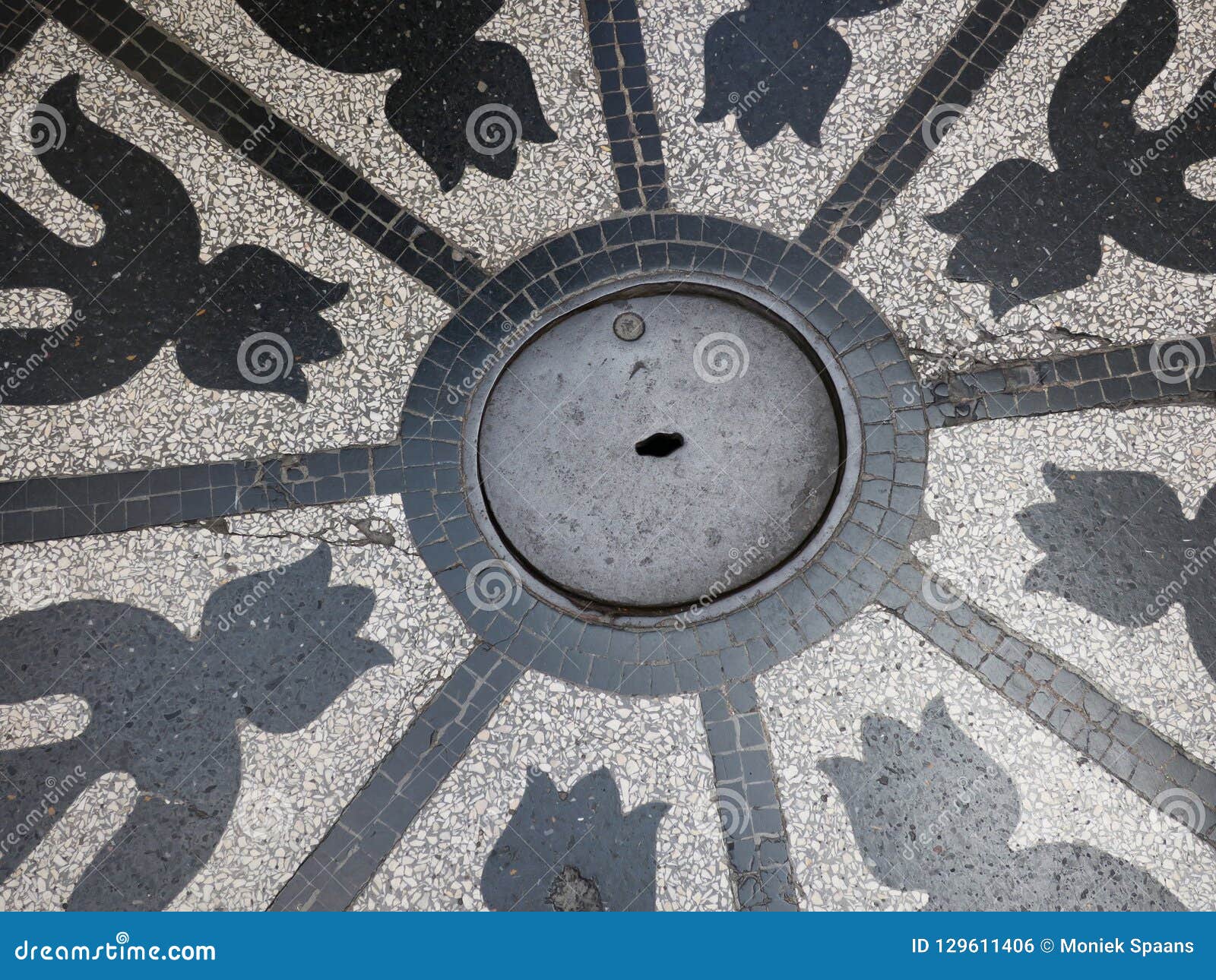 man hole cover with tulip formed decorations in granito