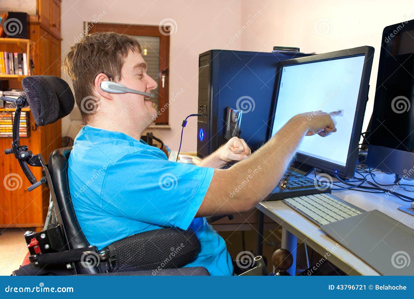 man with infantile cerebral palsy using a computer.