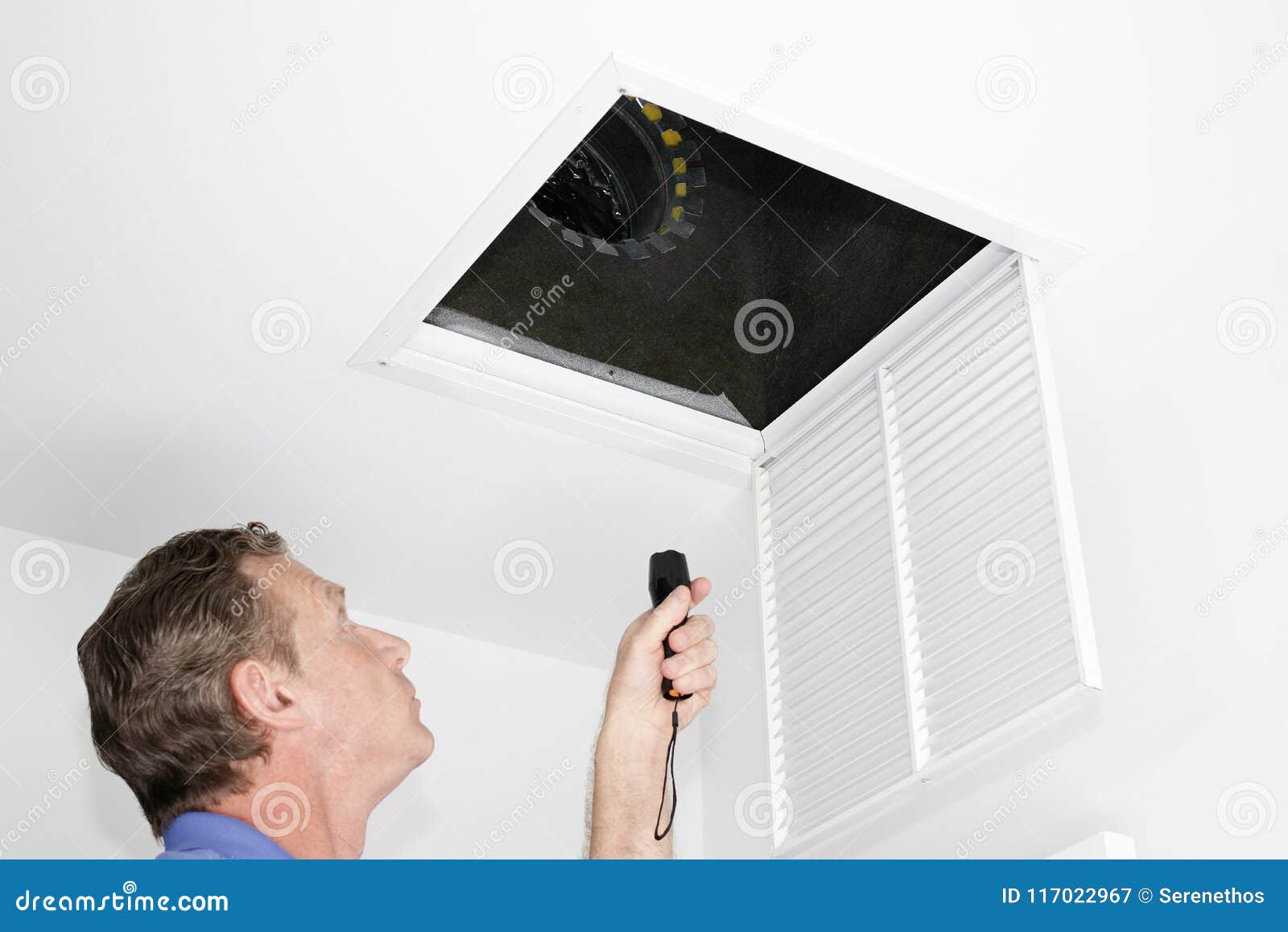man inspecting air intake duct