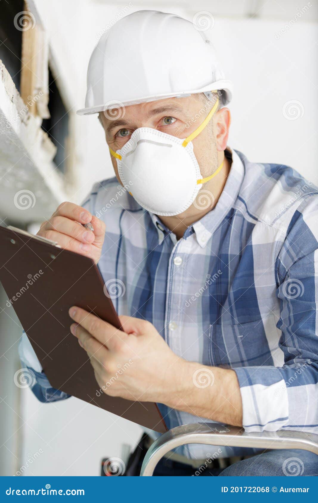 man inspecting derelict property wearing dust mask