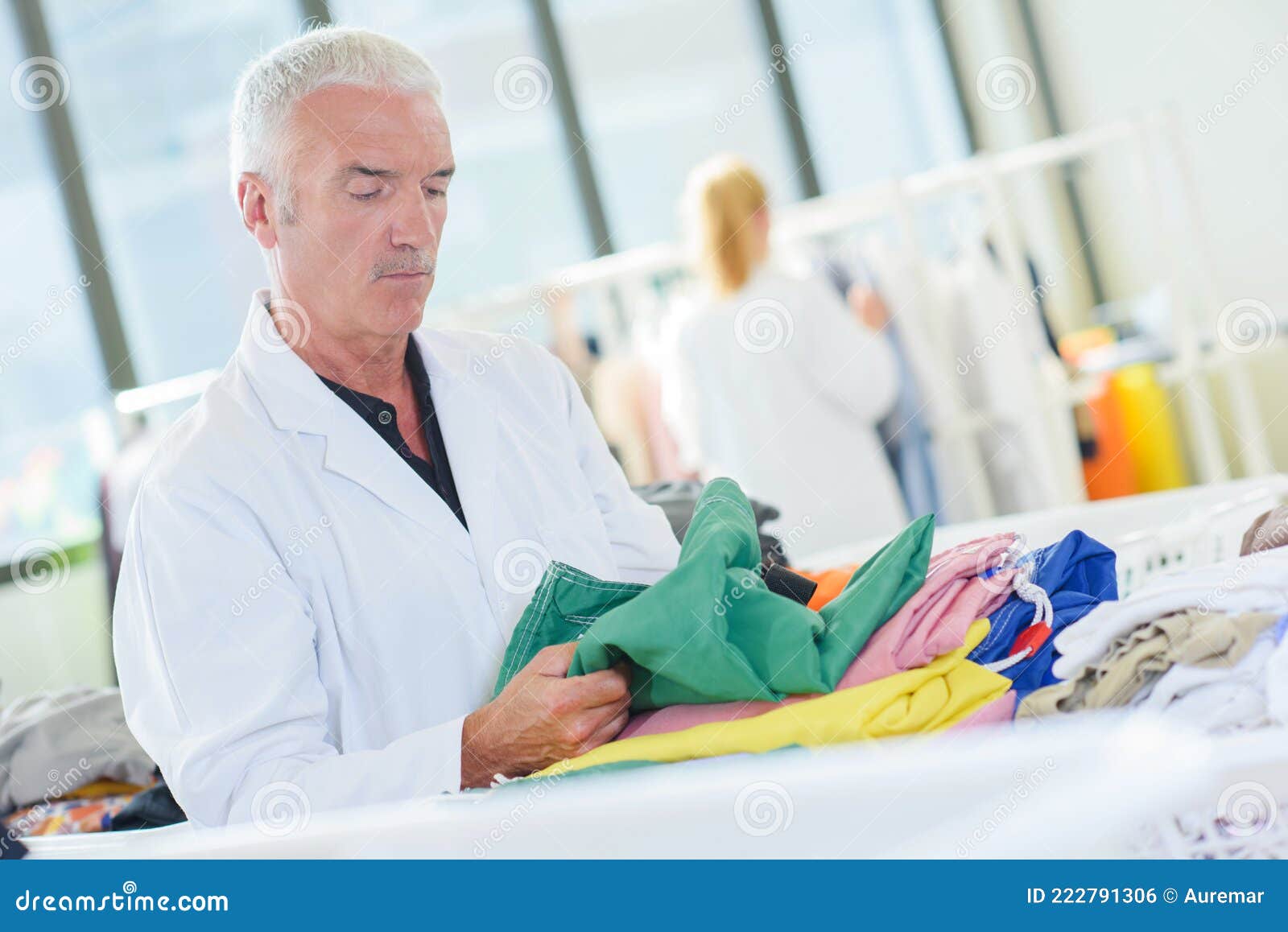 Man Inspecting Garment in Laundry Stock Photo Image of chore, textile