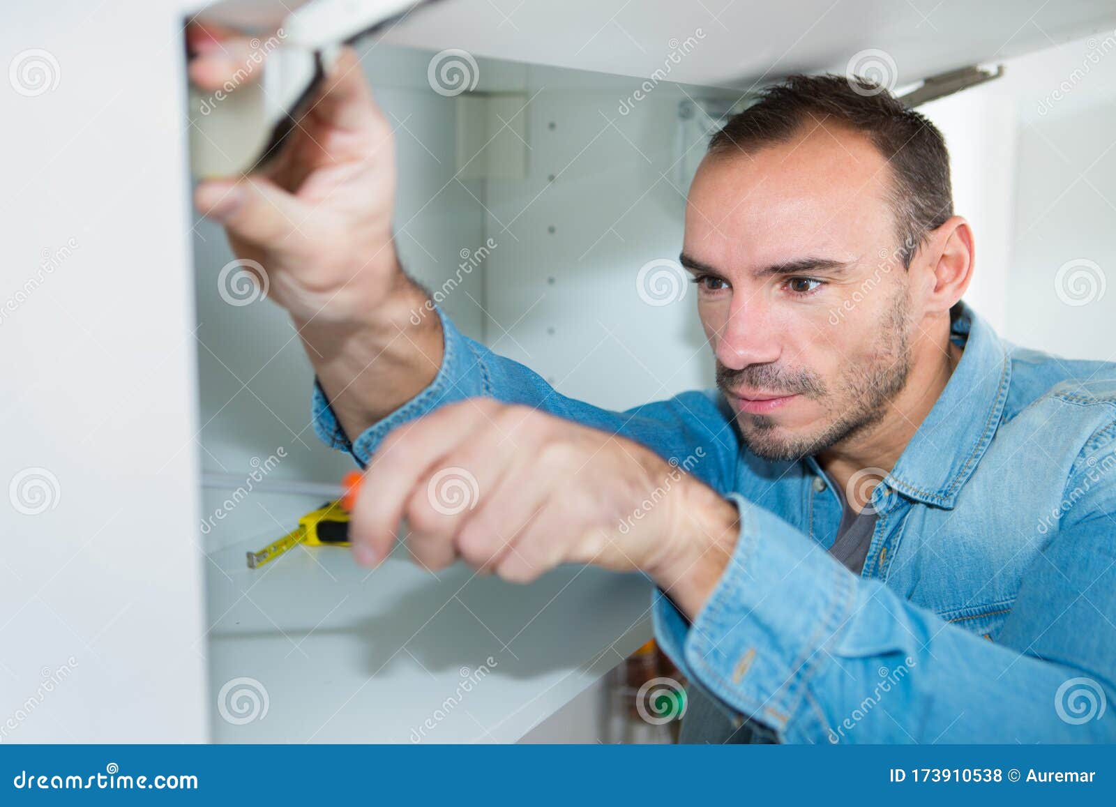 Man during Installation Kitchen Furniture Stock Photo Image of