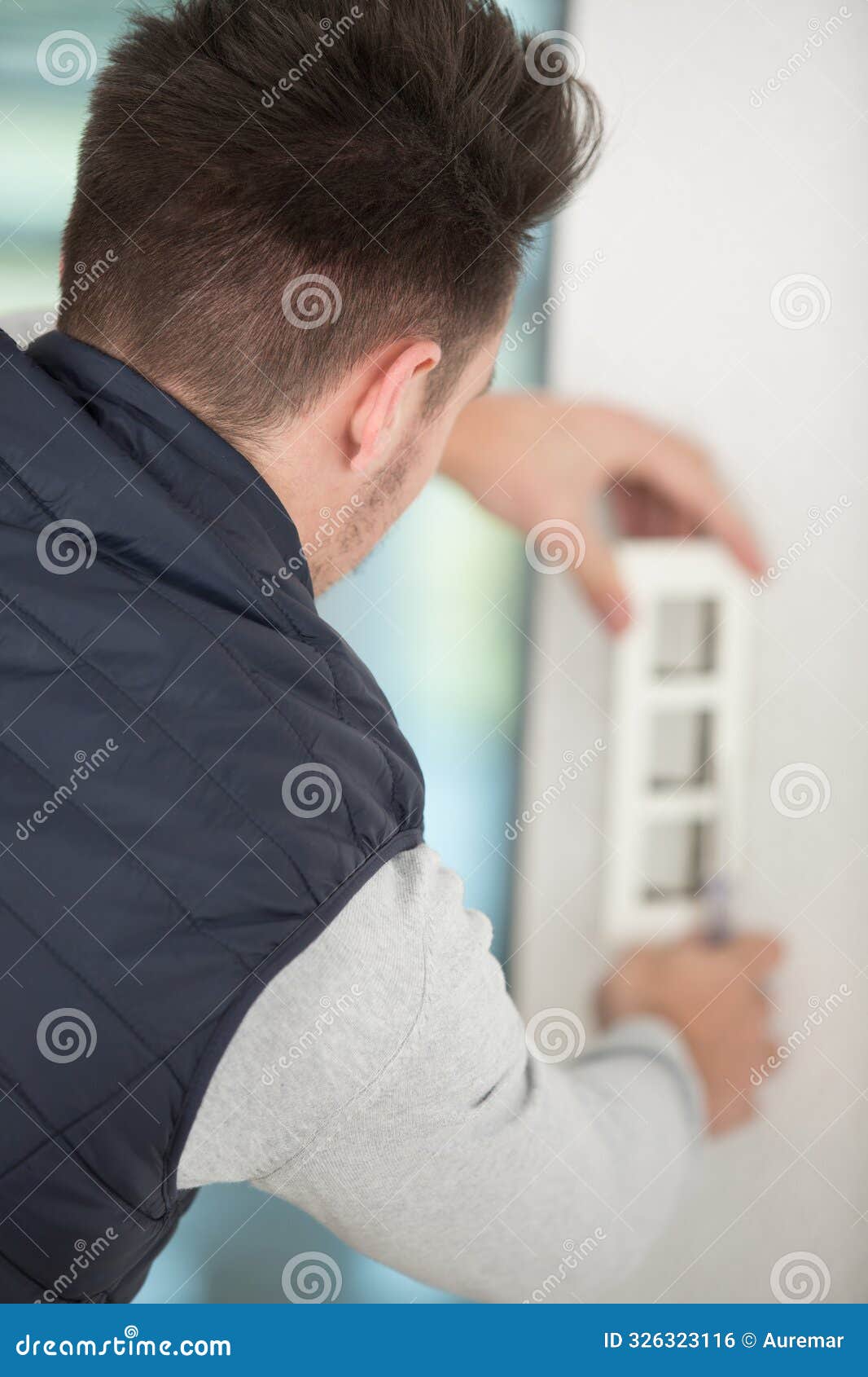 man installing group electrical outlets
