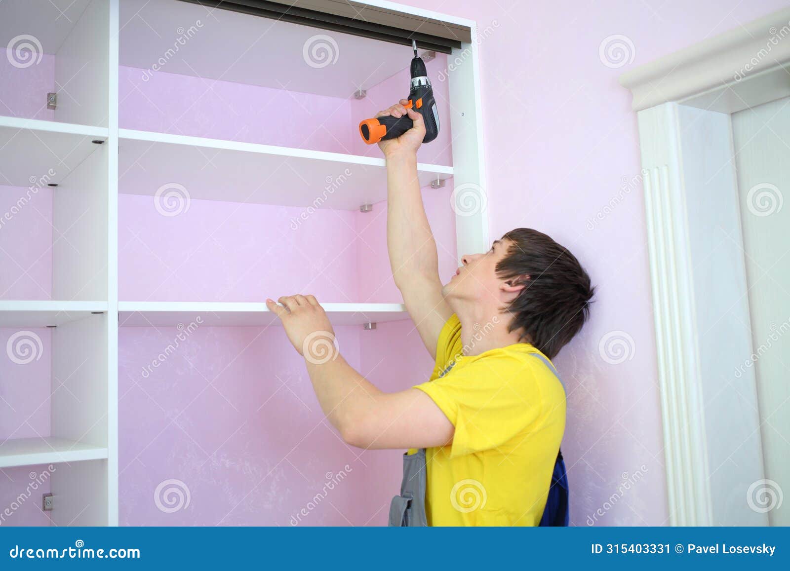 man installing guide rails for sliding wardrobe in