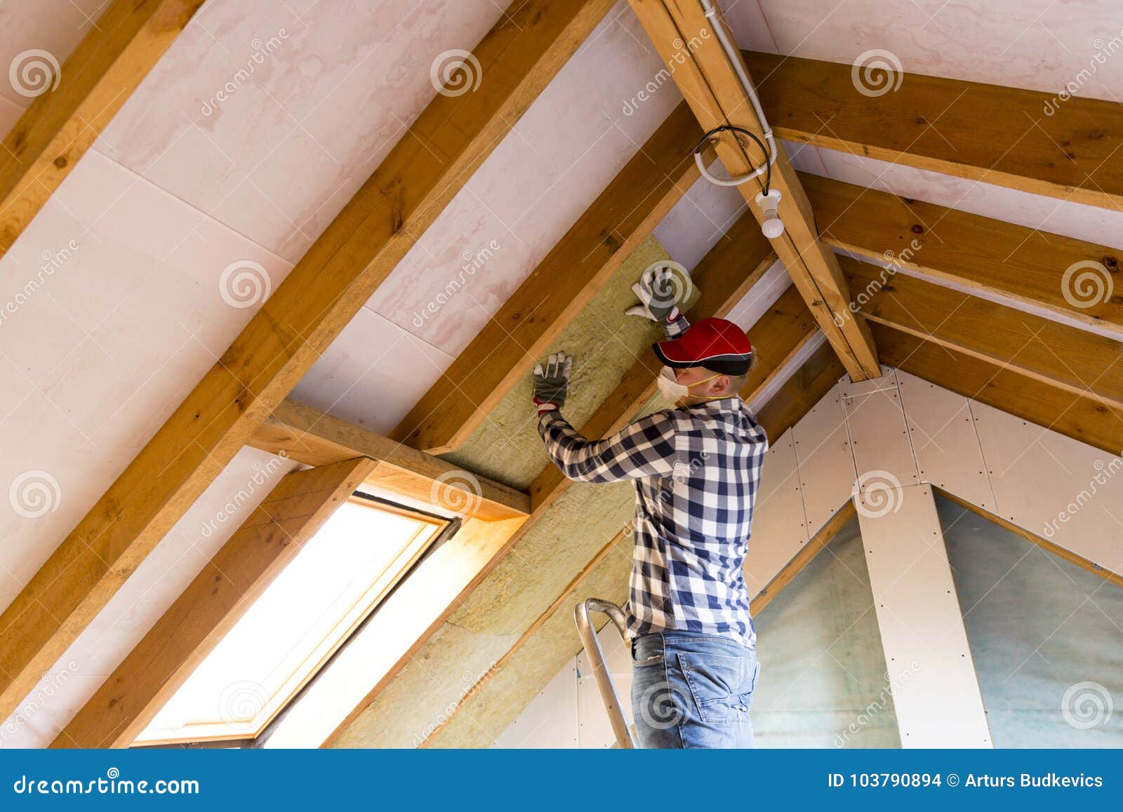 Man Installing Thermal Roof Insulation Layer Using Mineral Woo