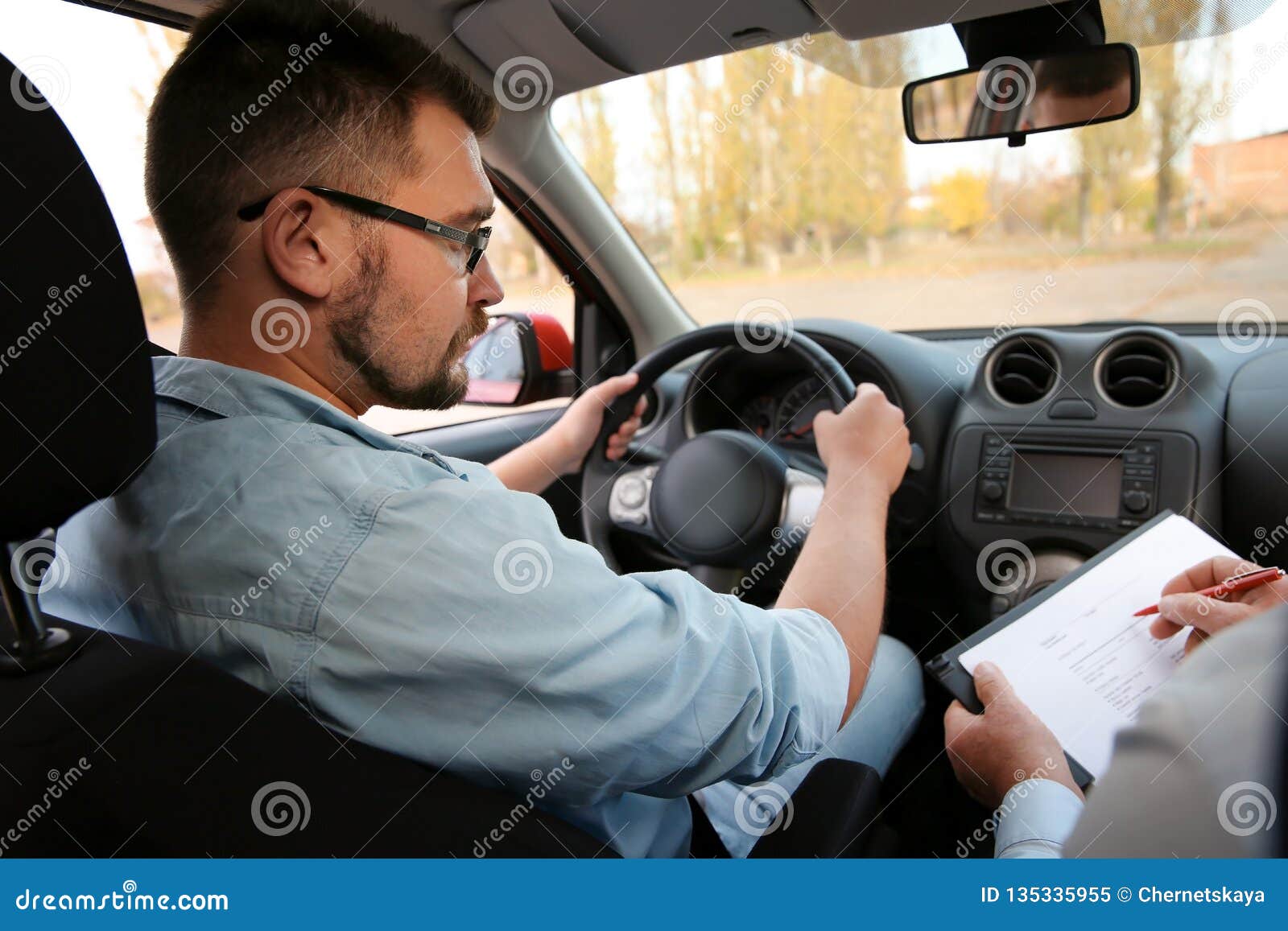 Man and instructor in car. stock image. Image of regulations 135335955