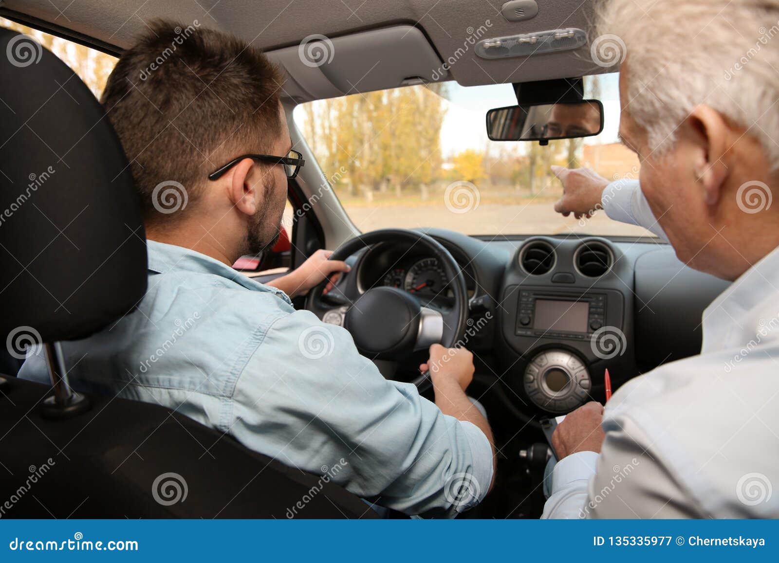 Man and instructor in car. stock image. Image of road 135335977