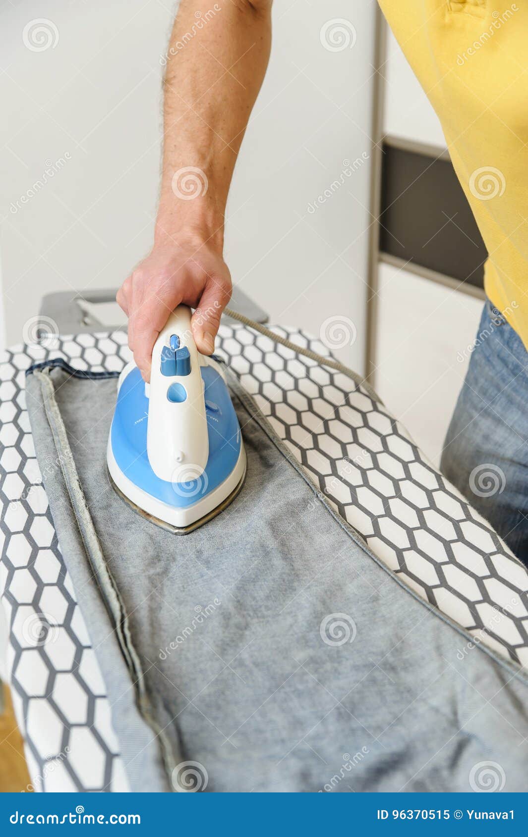 A man is ironing a jeans. stock image. Image of cleaning 96370515