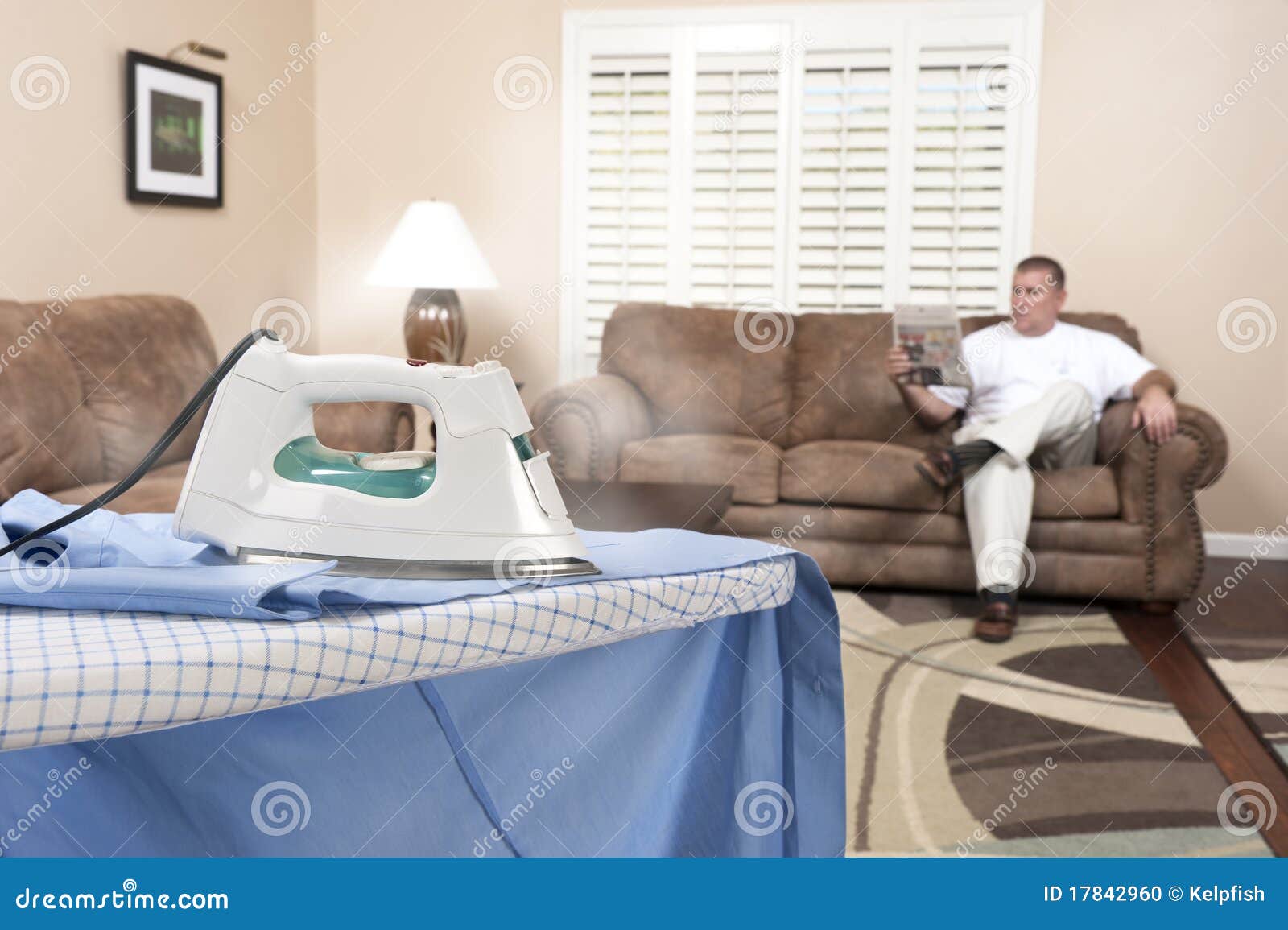 Man ironing shirt stock photo. Image of 17842960