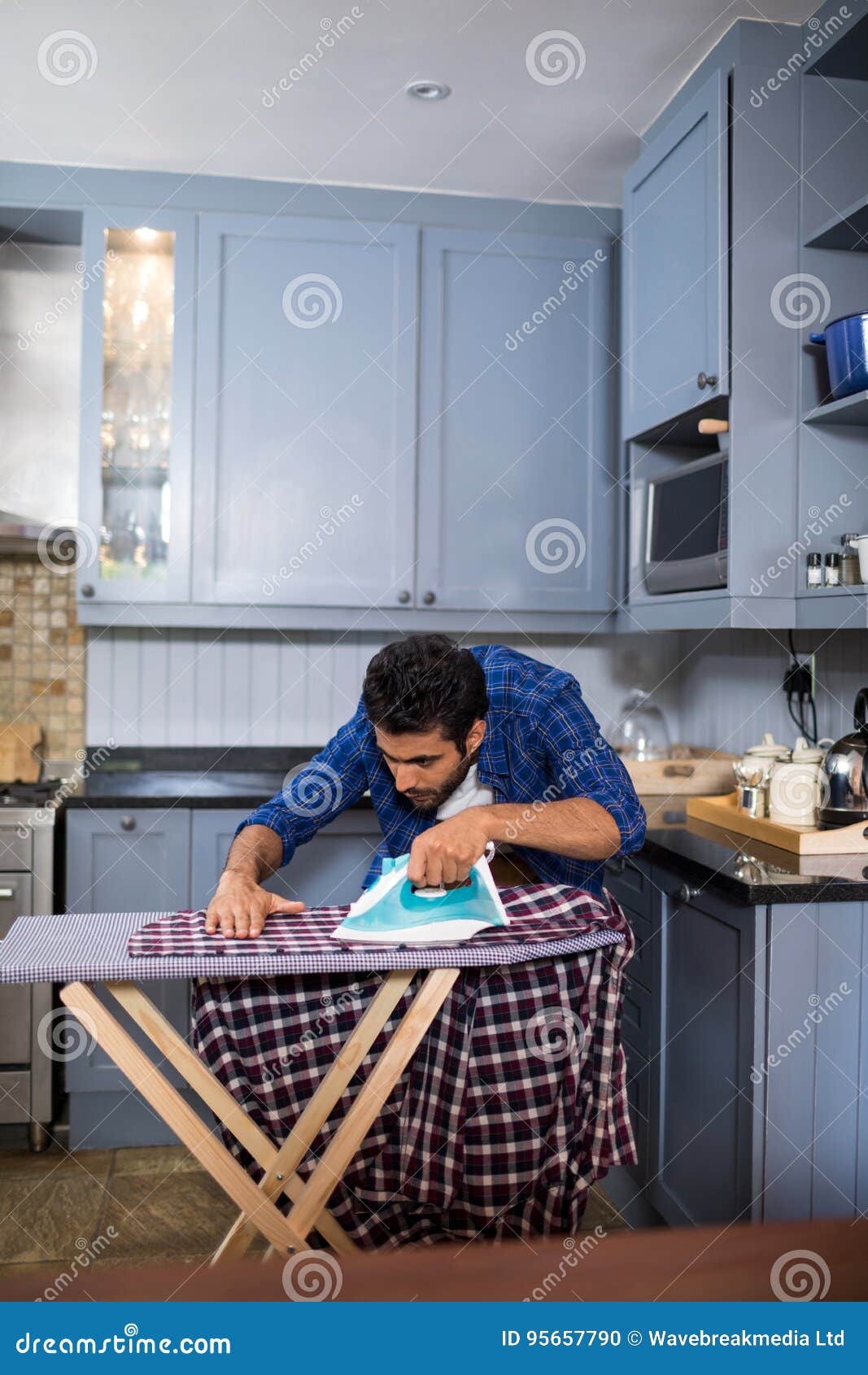 Man Ironing Shirt while Standing in Kitchen Stock Photo Image of